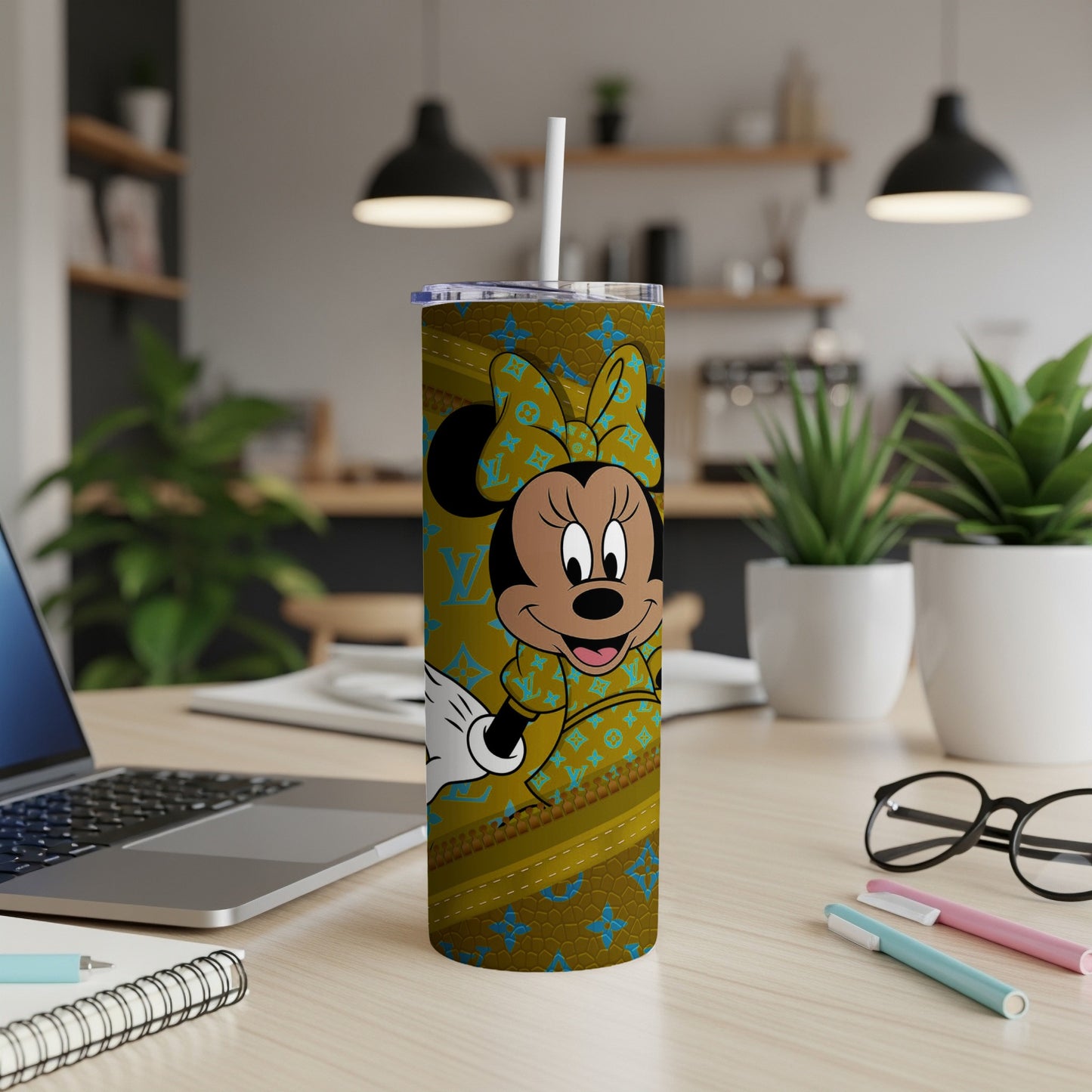 Minnie Mouse on a gold and brown patterned tumbler with a straw.
