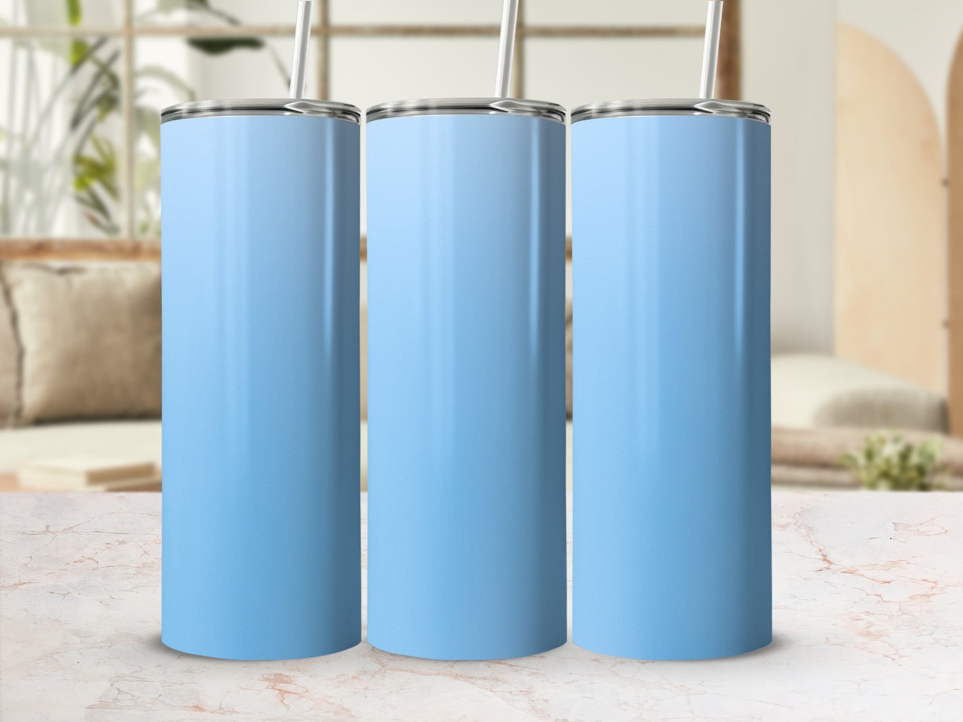 Three light blue stainless steel tumblers with straws side by side.