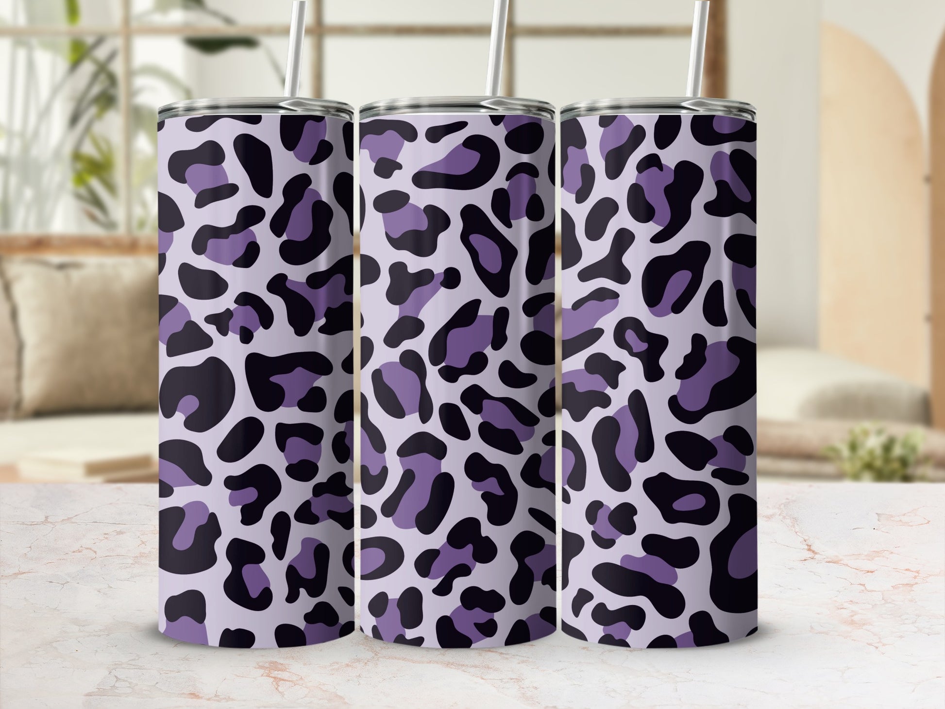 Three tumblers with purple and black leopard print on a light gray background.
