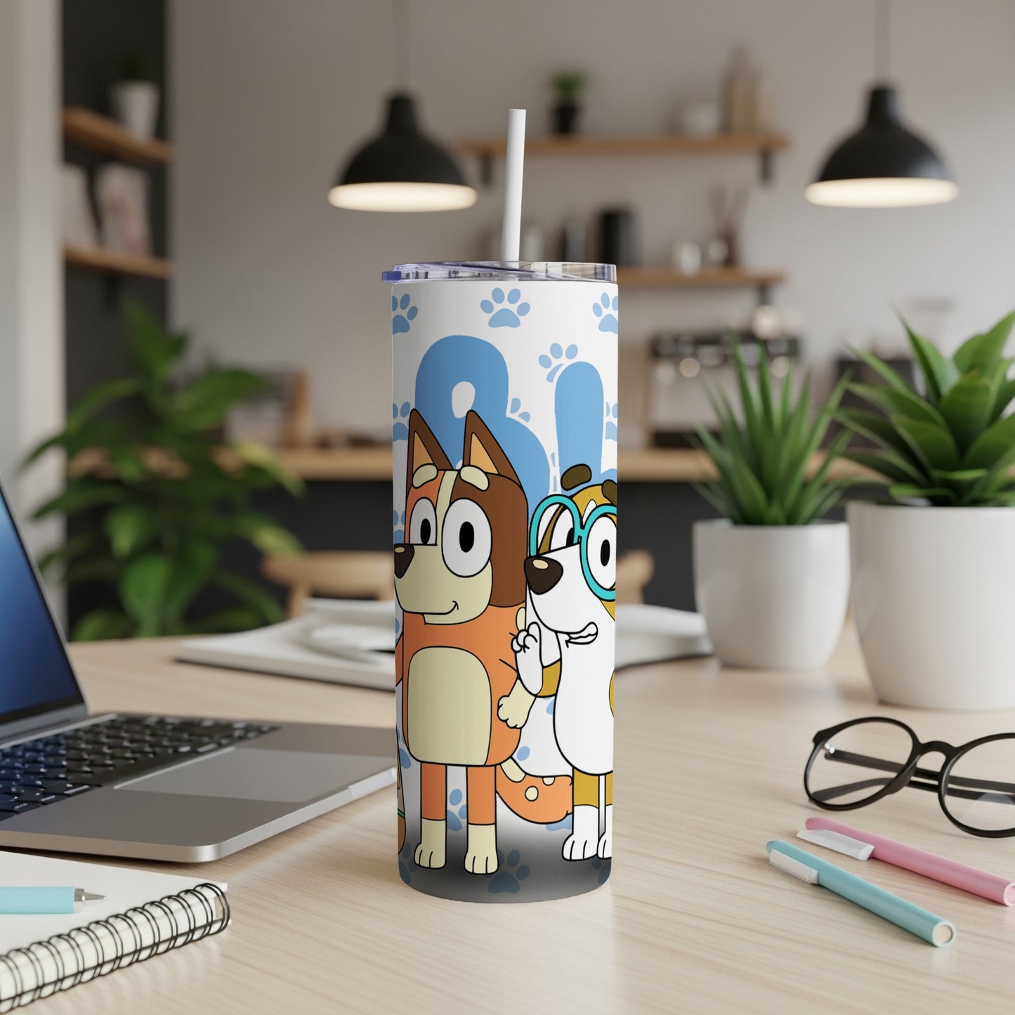 Bluey and Bingo characters on a blue and white patterned tumbler with straw.