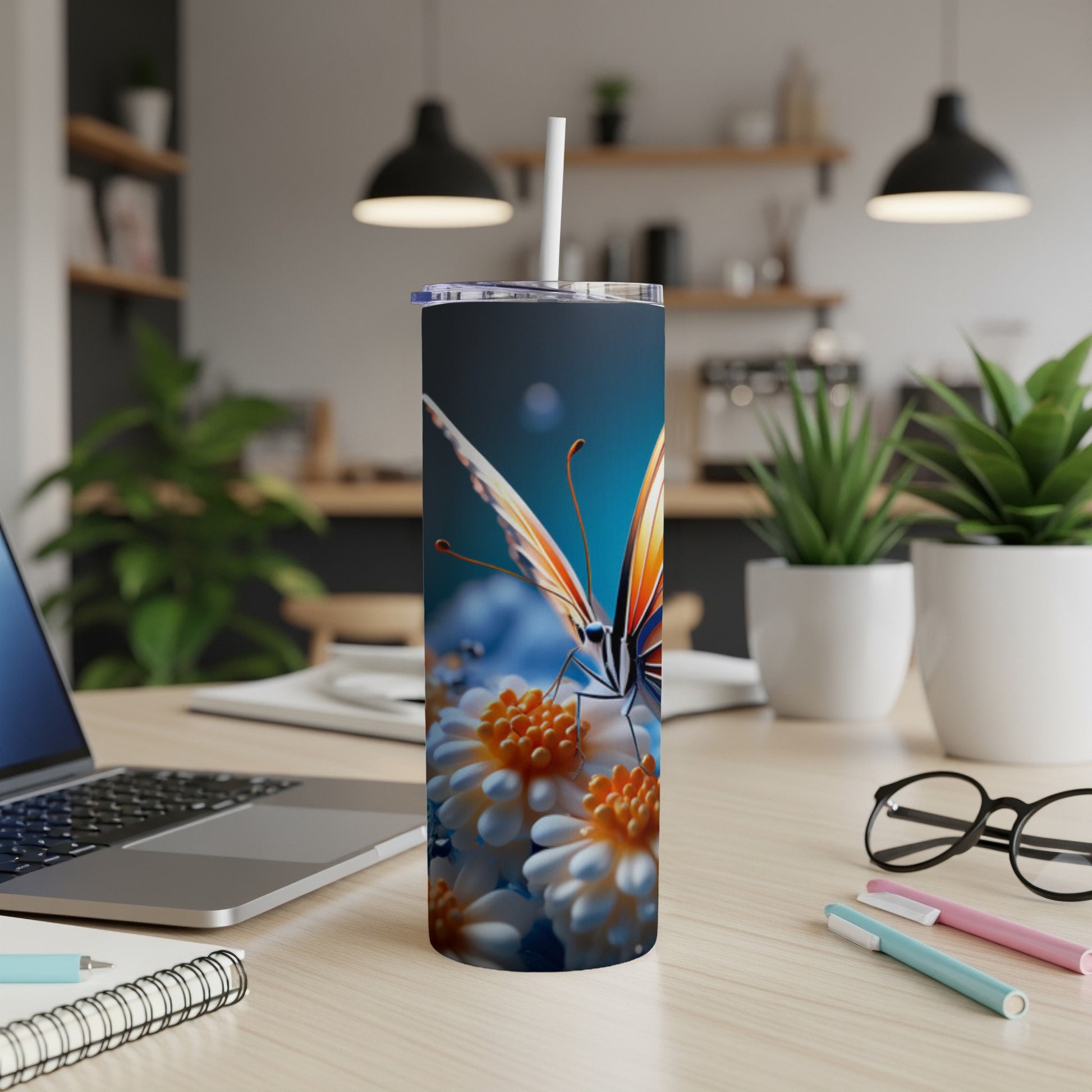 Butterfly on daisies on a skinny tumbler with straw.