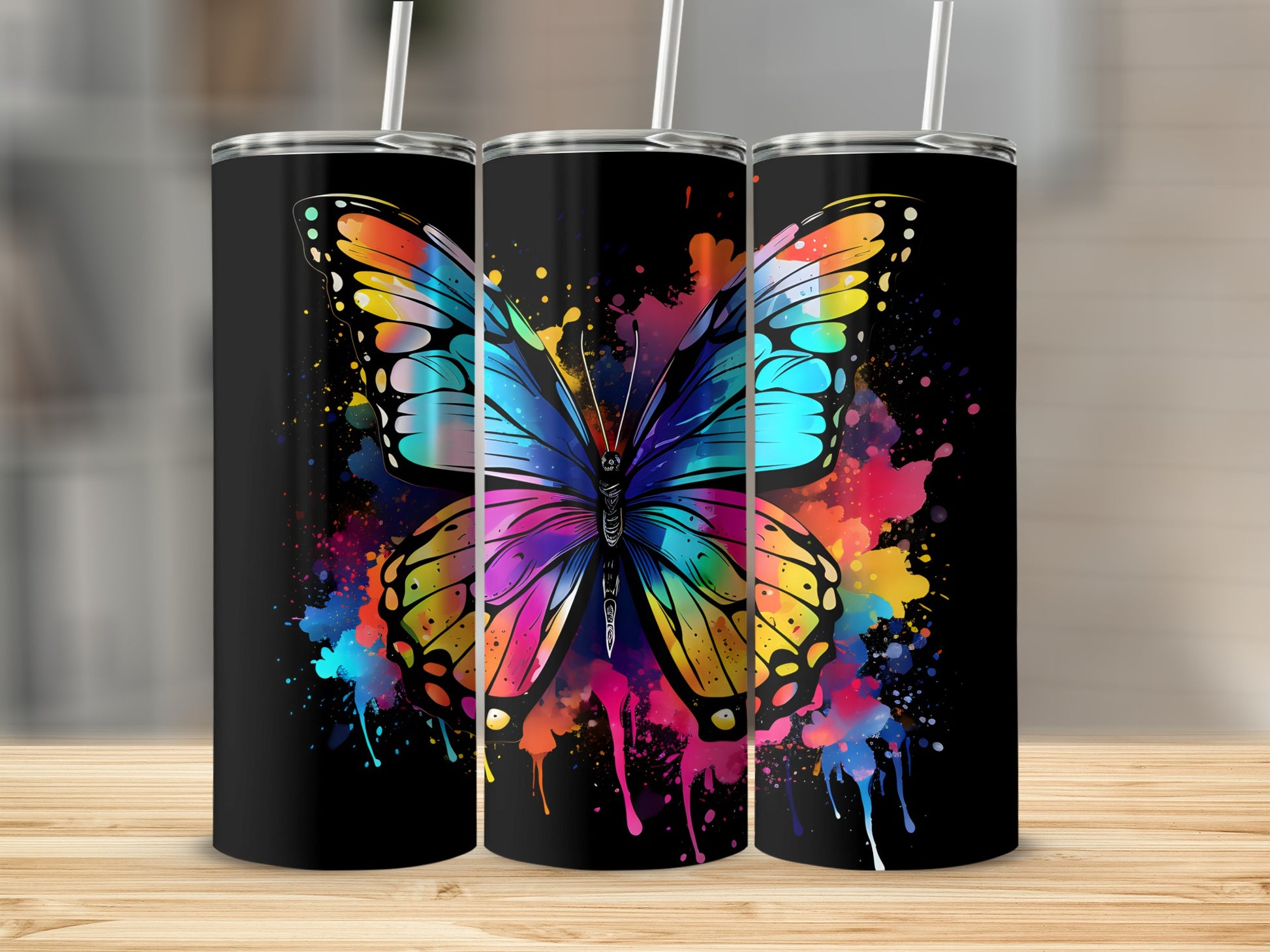 Black tumblers with vibrant butterfly and paint splatter design.