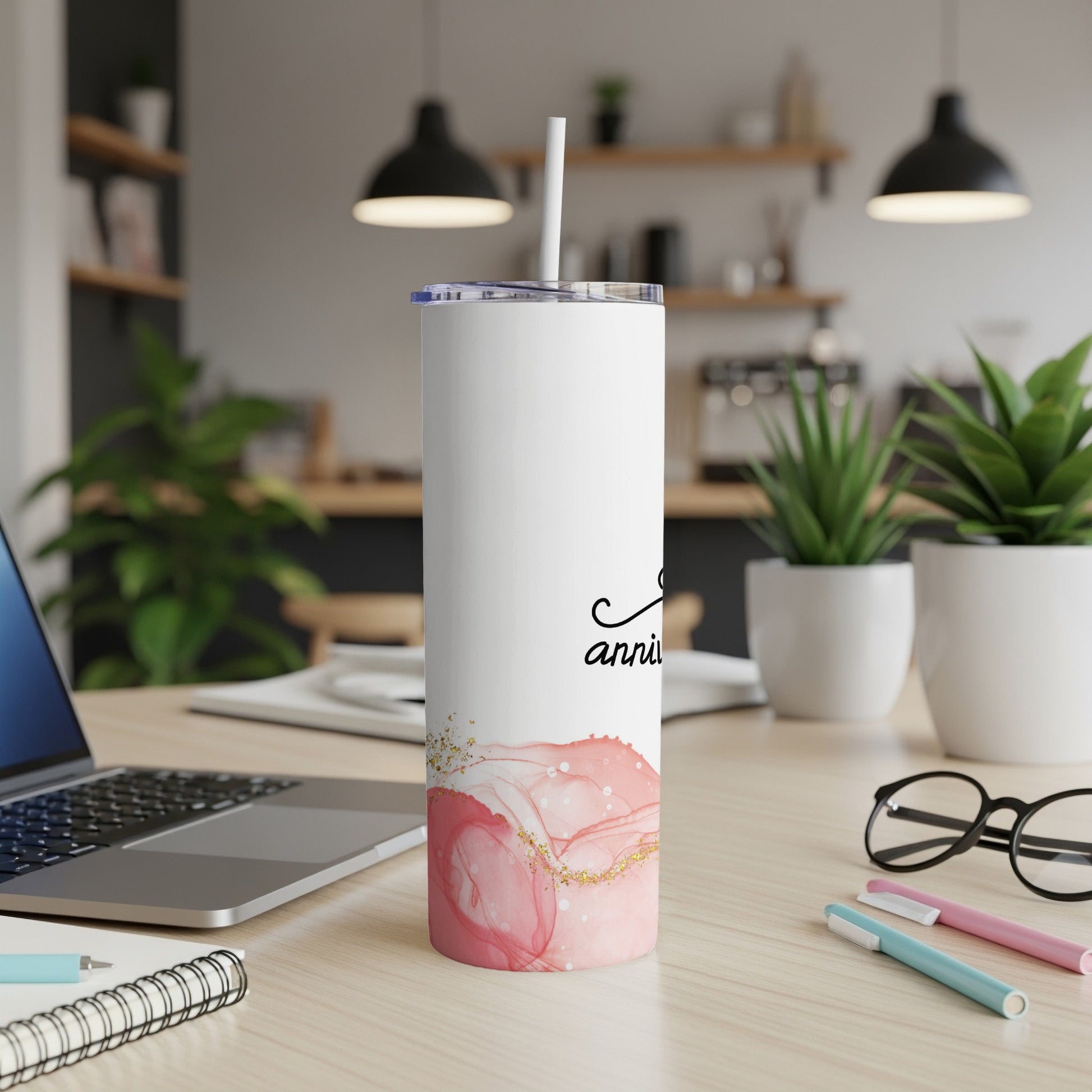 White tumbler with pink marble design and gold accents.