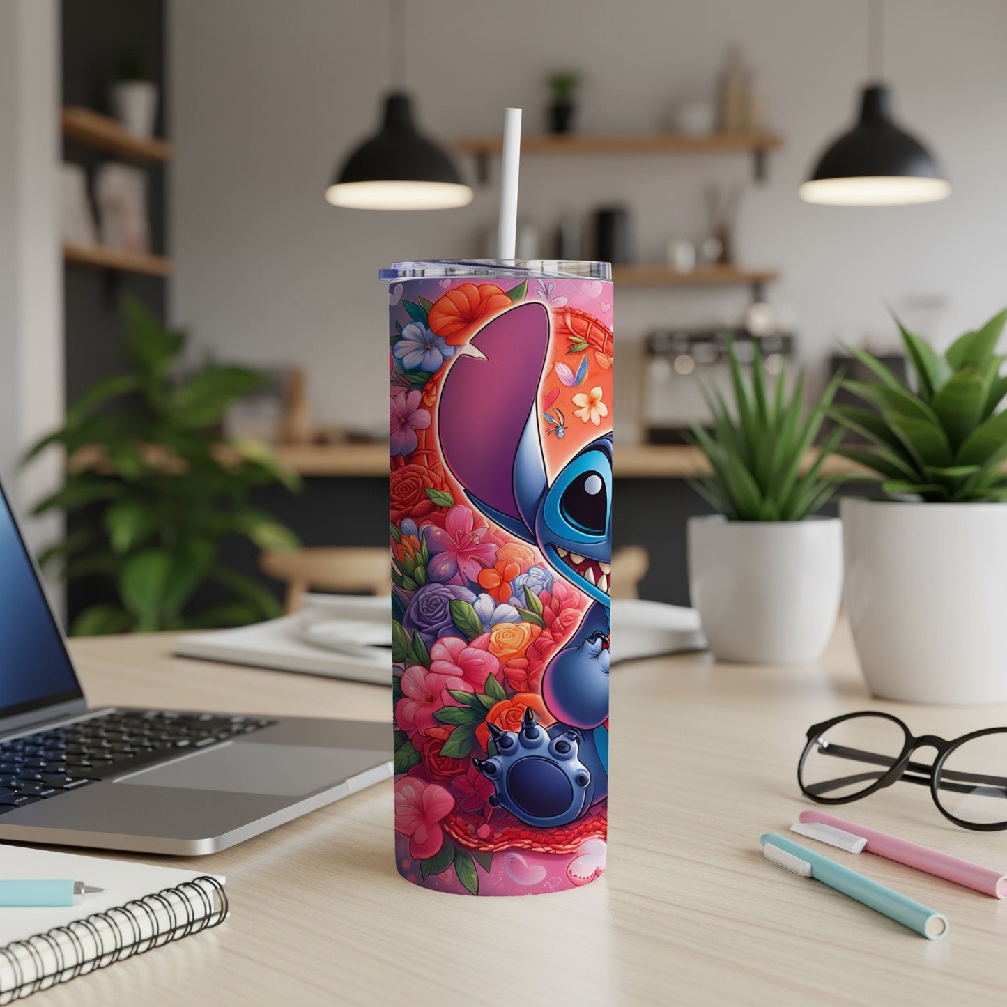 Stitch character on pink floral tumbler with white straw, on desk.