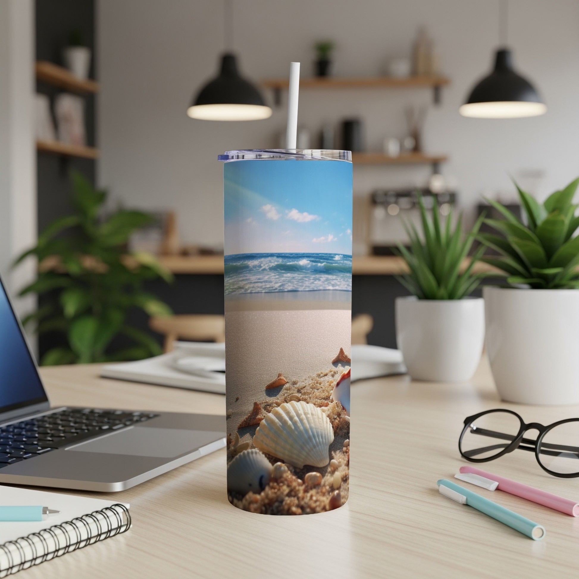 Beach scene with seashells on sand on a skinny tumbler.