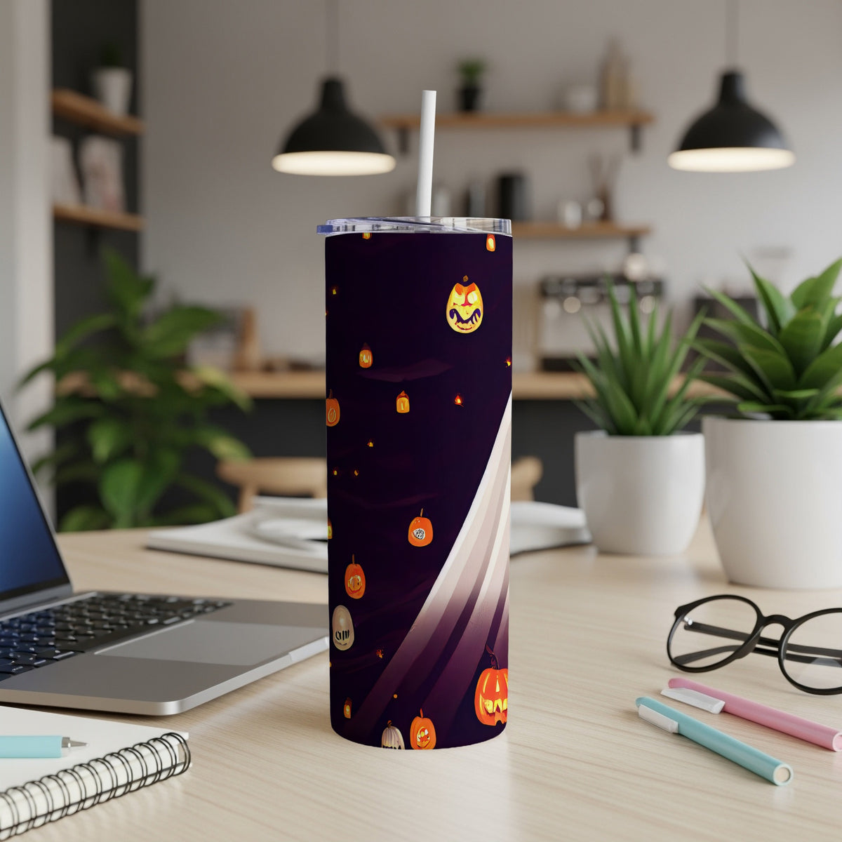 Halloween tumbler with pumpkins and ghosts on a dark purple background.