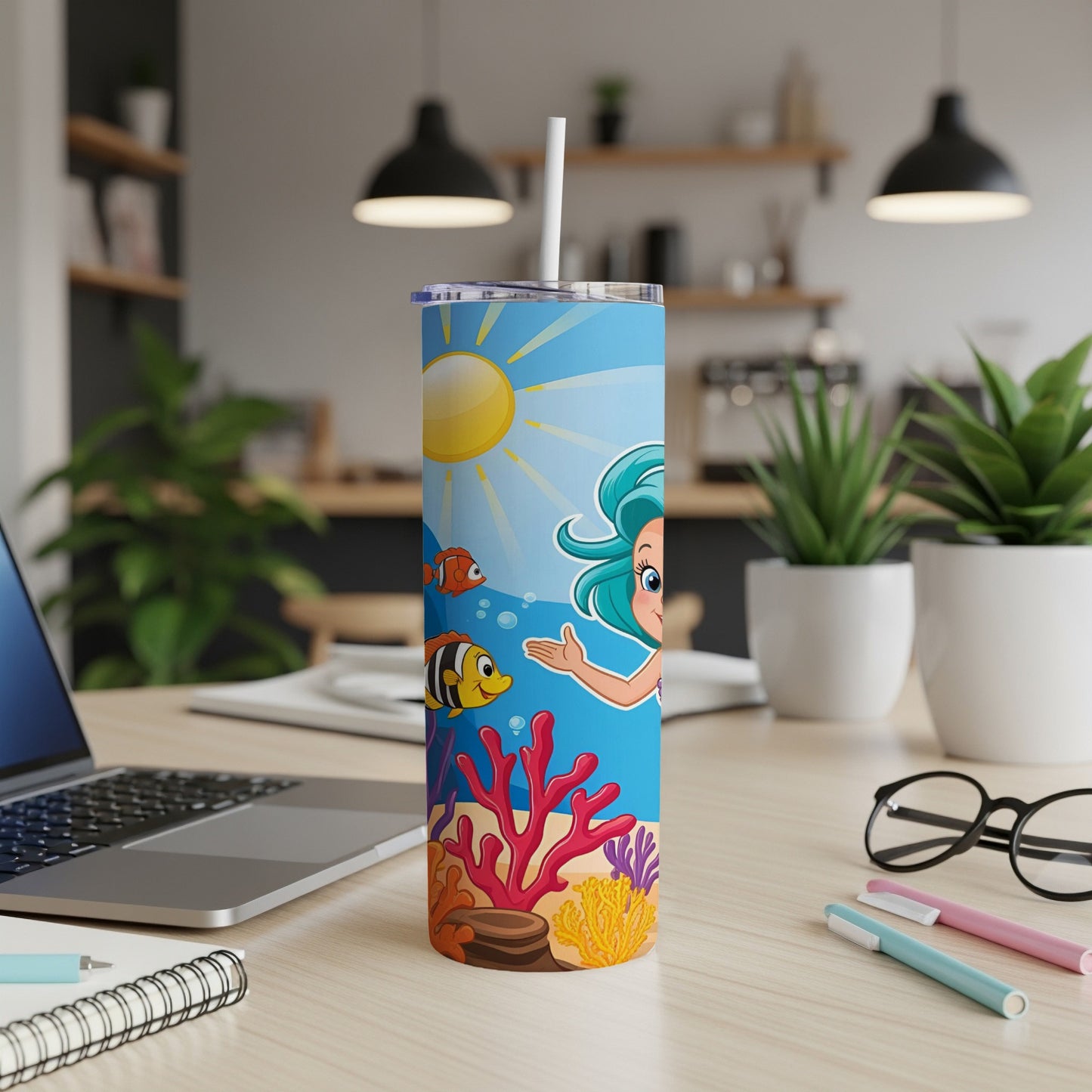 Mermaid and fish on a blue tumbler with coral and sun.