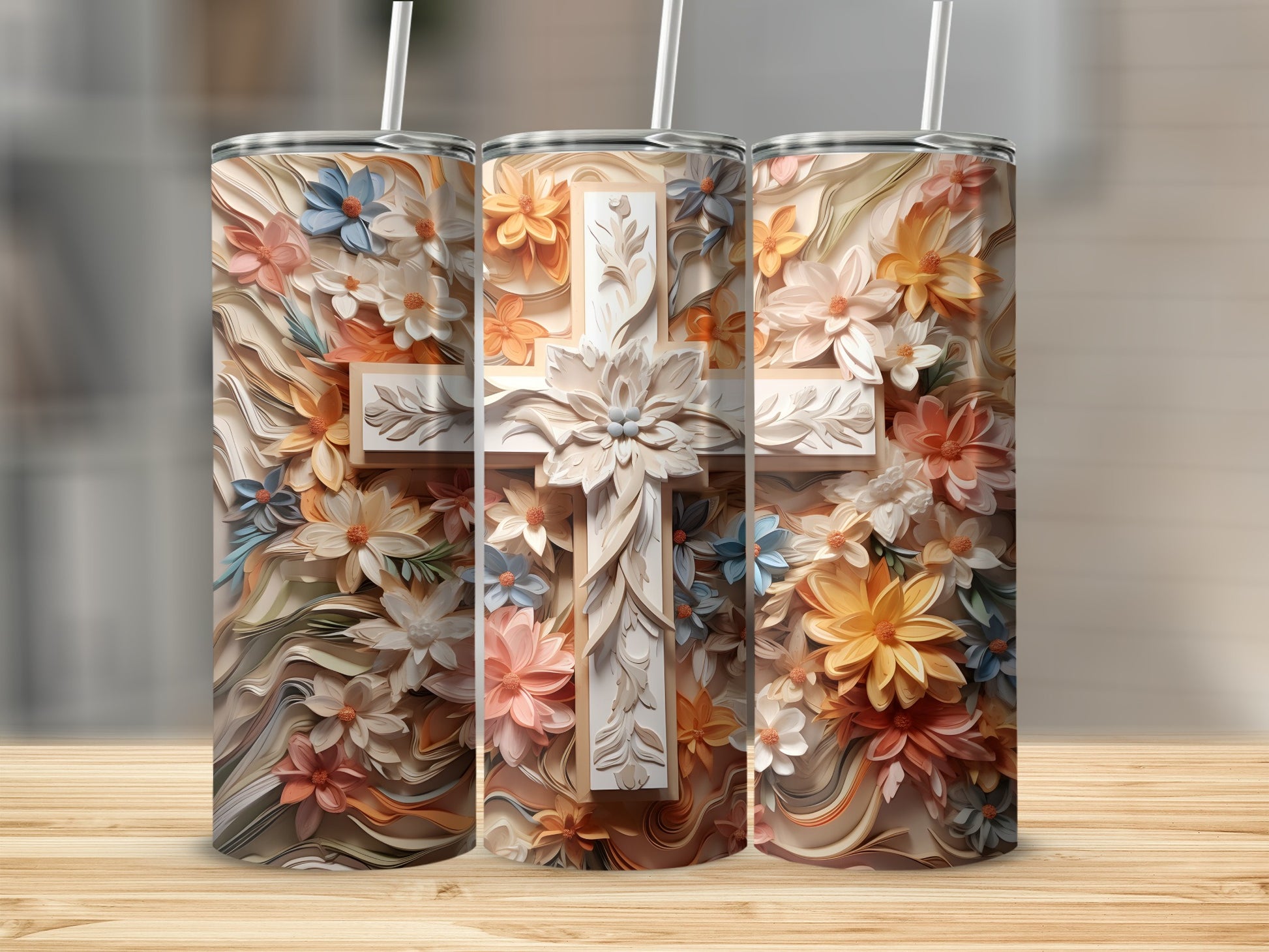Three tumblers adorned with a floral cross design.