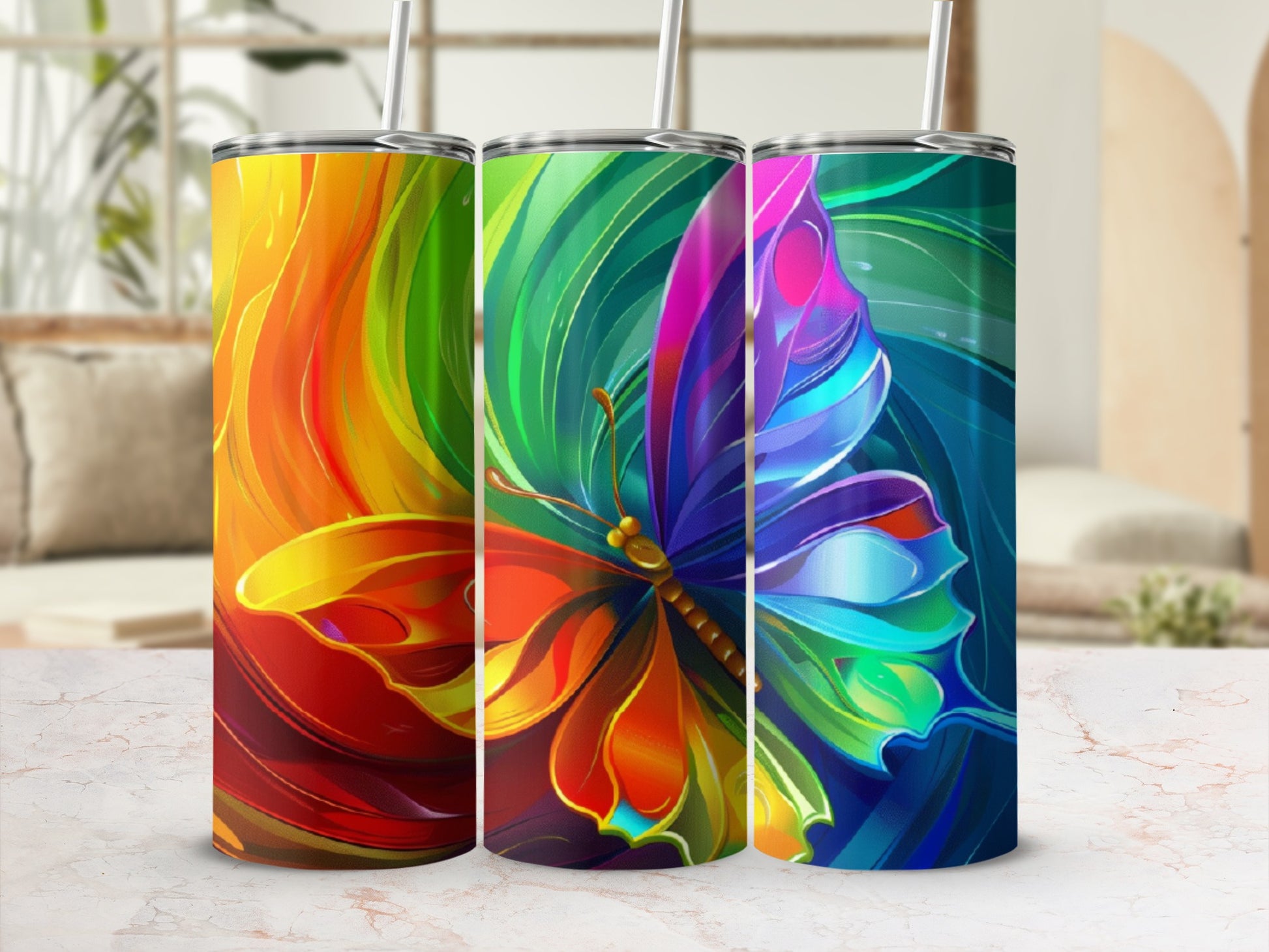 Three tumblers with colorful butterfly designs and abstract backgrounds.