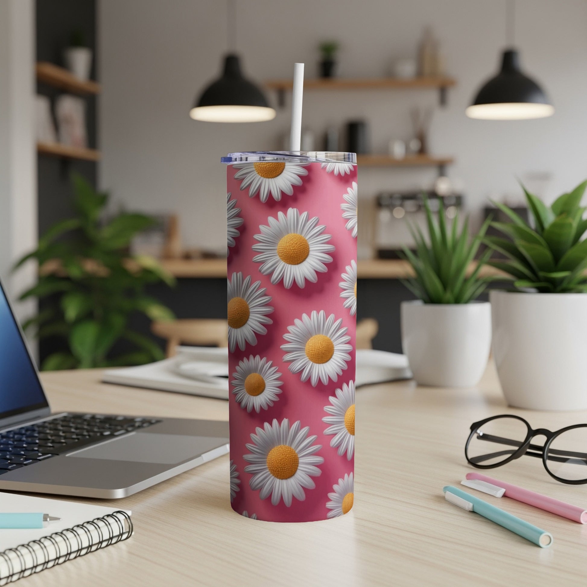 Pink tumbler with a repeating pattern of white daisies and green leaves.