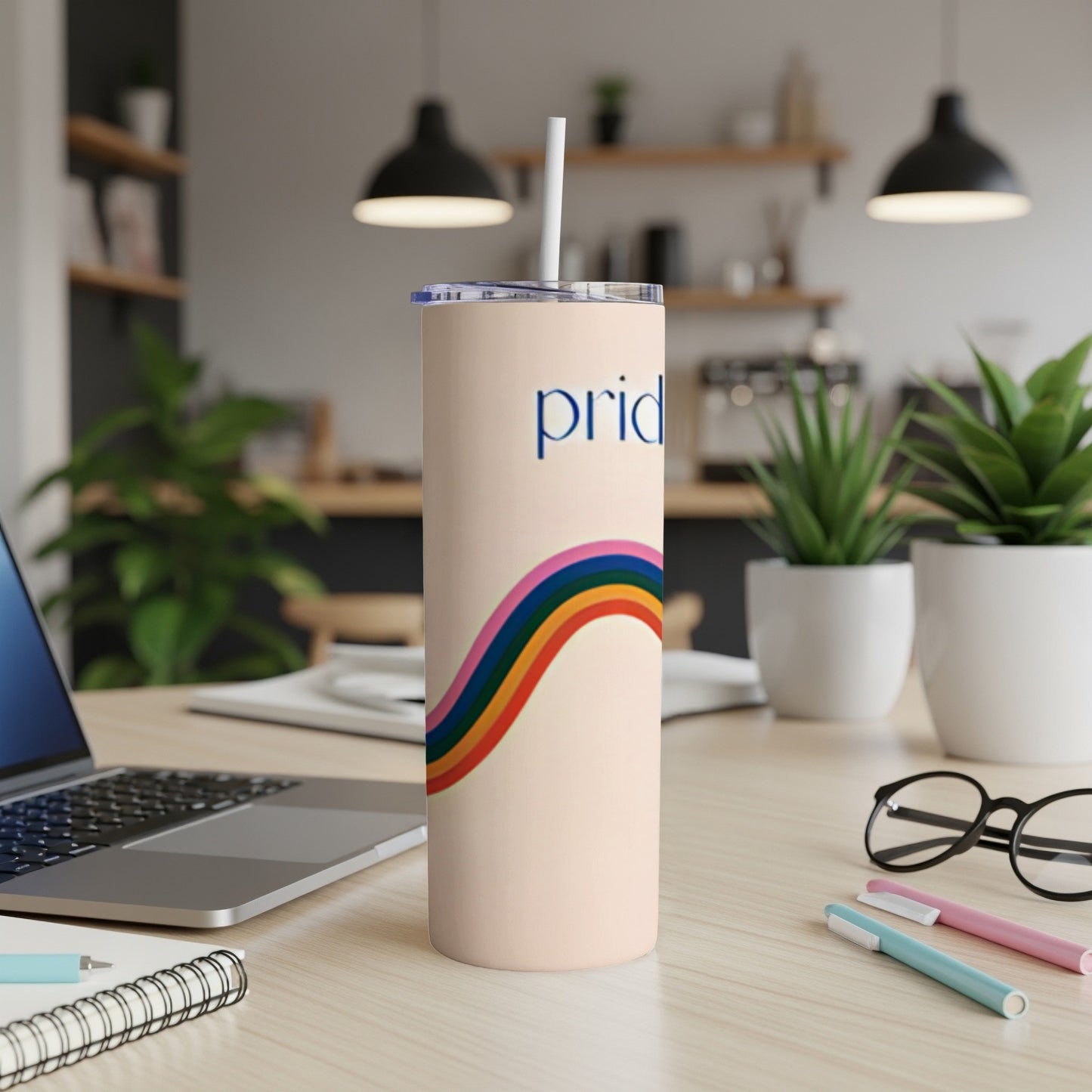 Pale pink tumbler with rainbow stripe and "pride" text.