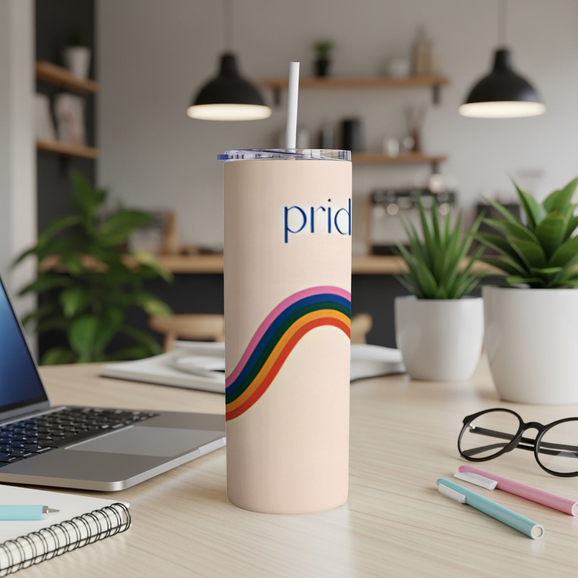 Pale pink tumbler with rainbow stripe and "pride" text.