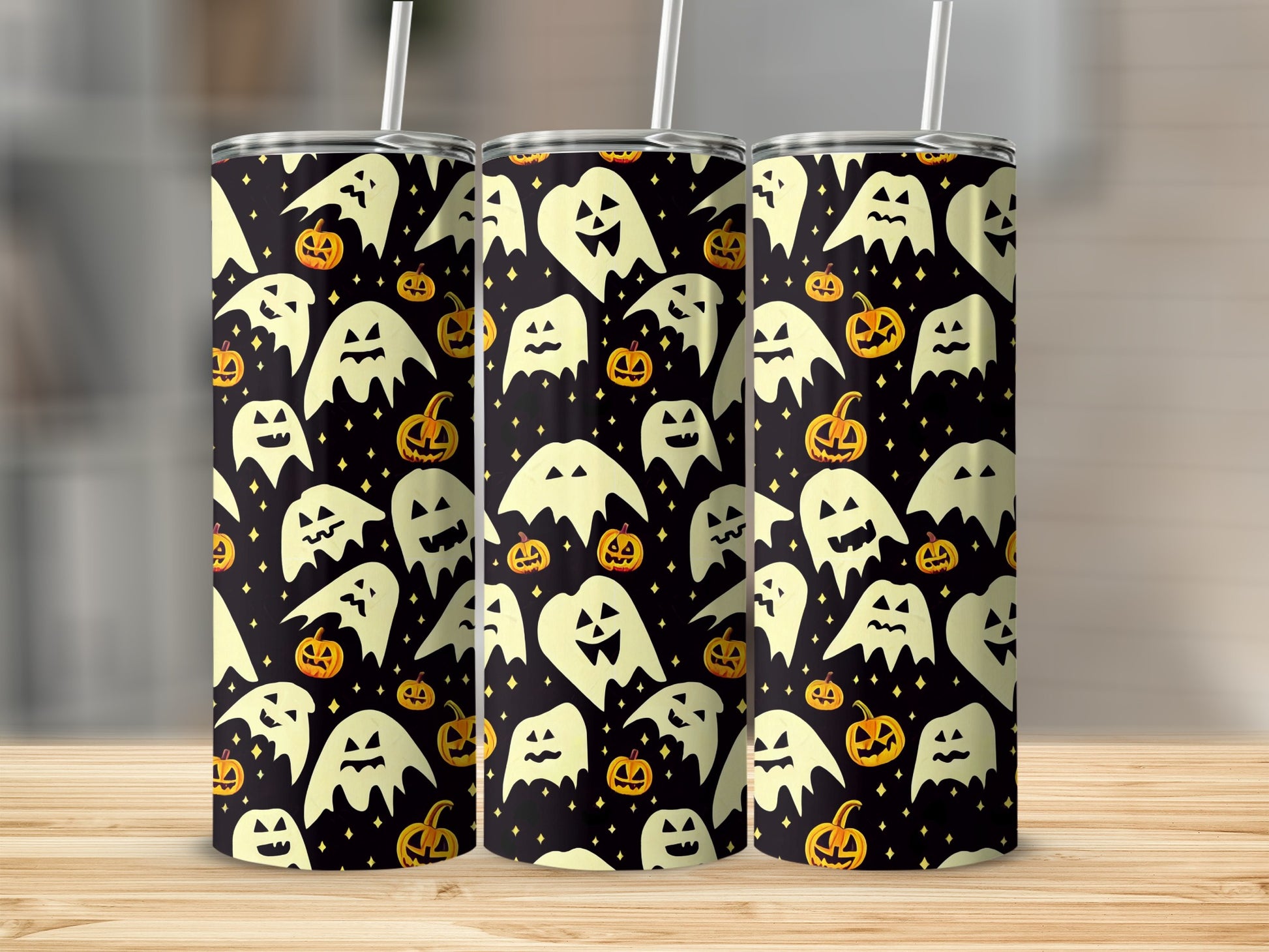 Tumblers with a Halloween pattern of white ghosts and pumpkins on a black background.