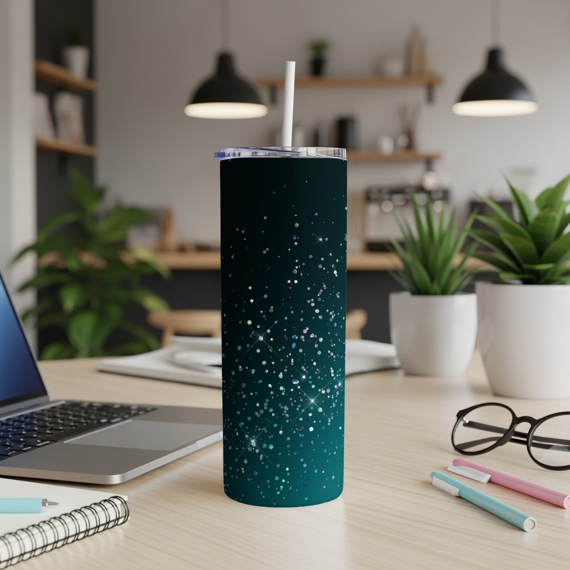 Teal skinny tumbler with glittery confetti pattern and white straw.