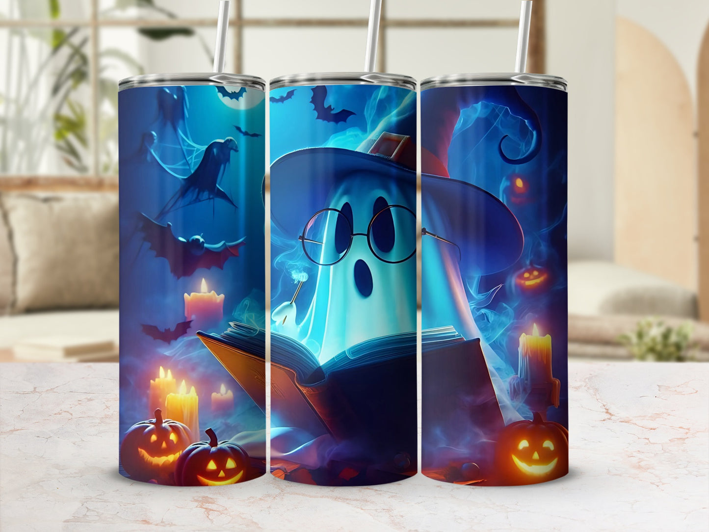 Halloween tumbler with a ghost reading a book surrounded by bats and pumpkins.