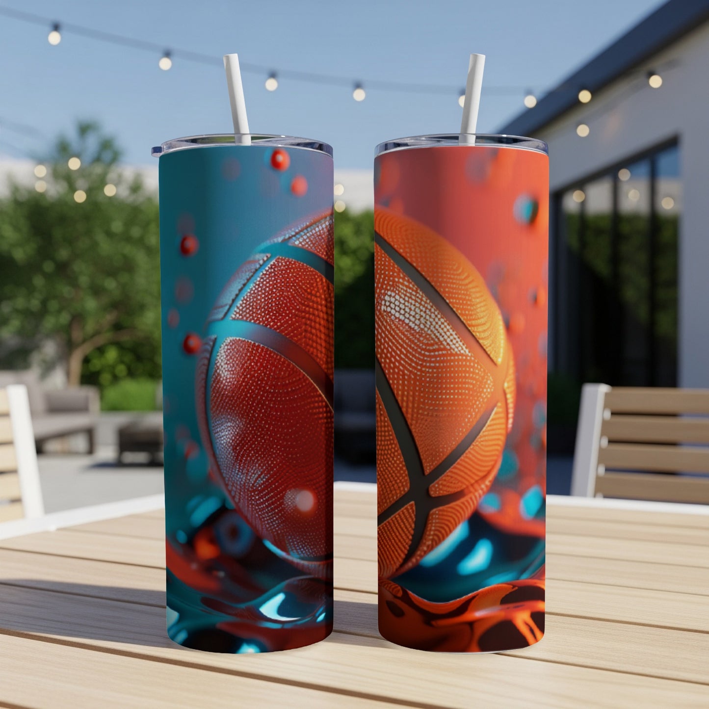 Two basketball tumblers with straws on a table outdoors.