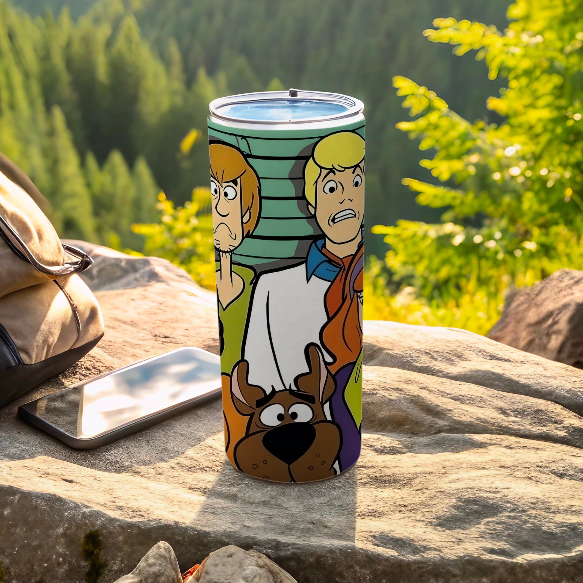 Scooby-Doo characters on a stainless steel tumbler, outdoors.