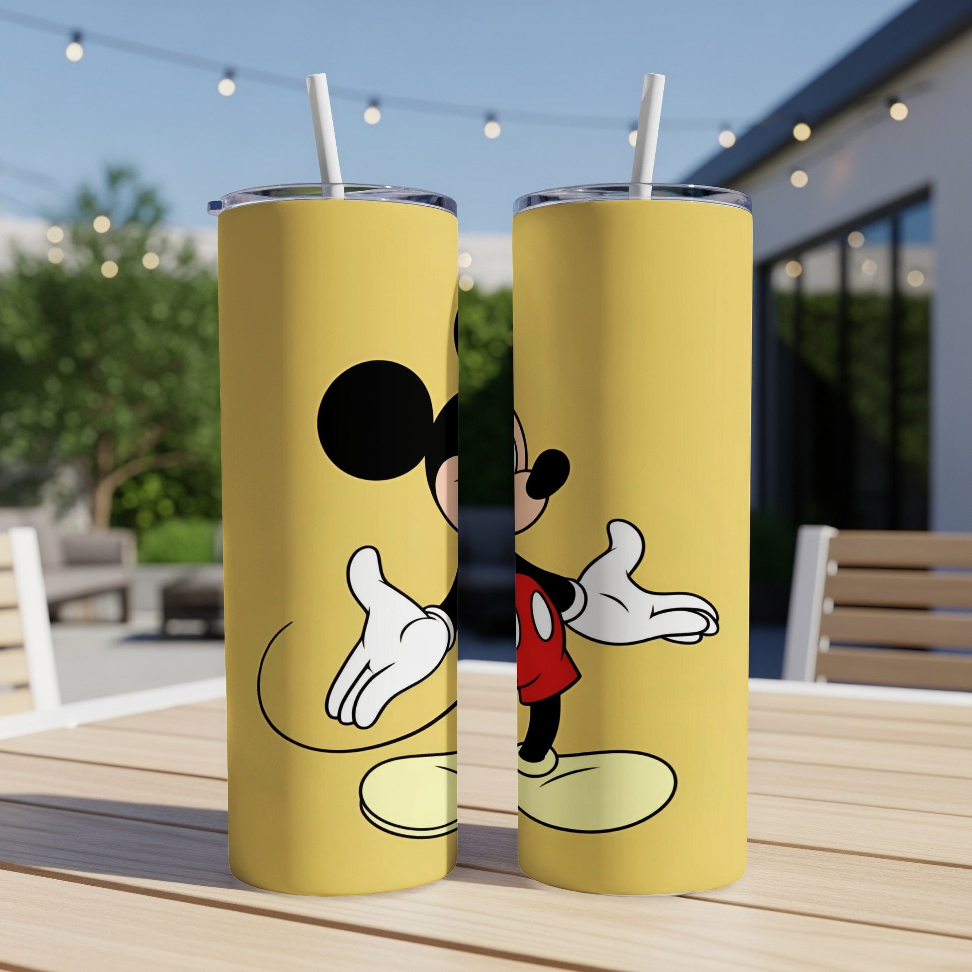 Two yellow tumblers featuring Mickey Mouse standing with arms outstretched.
