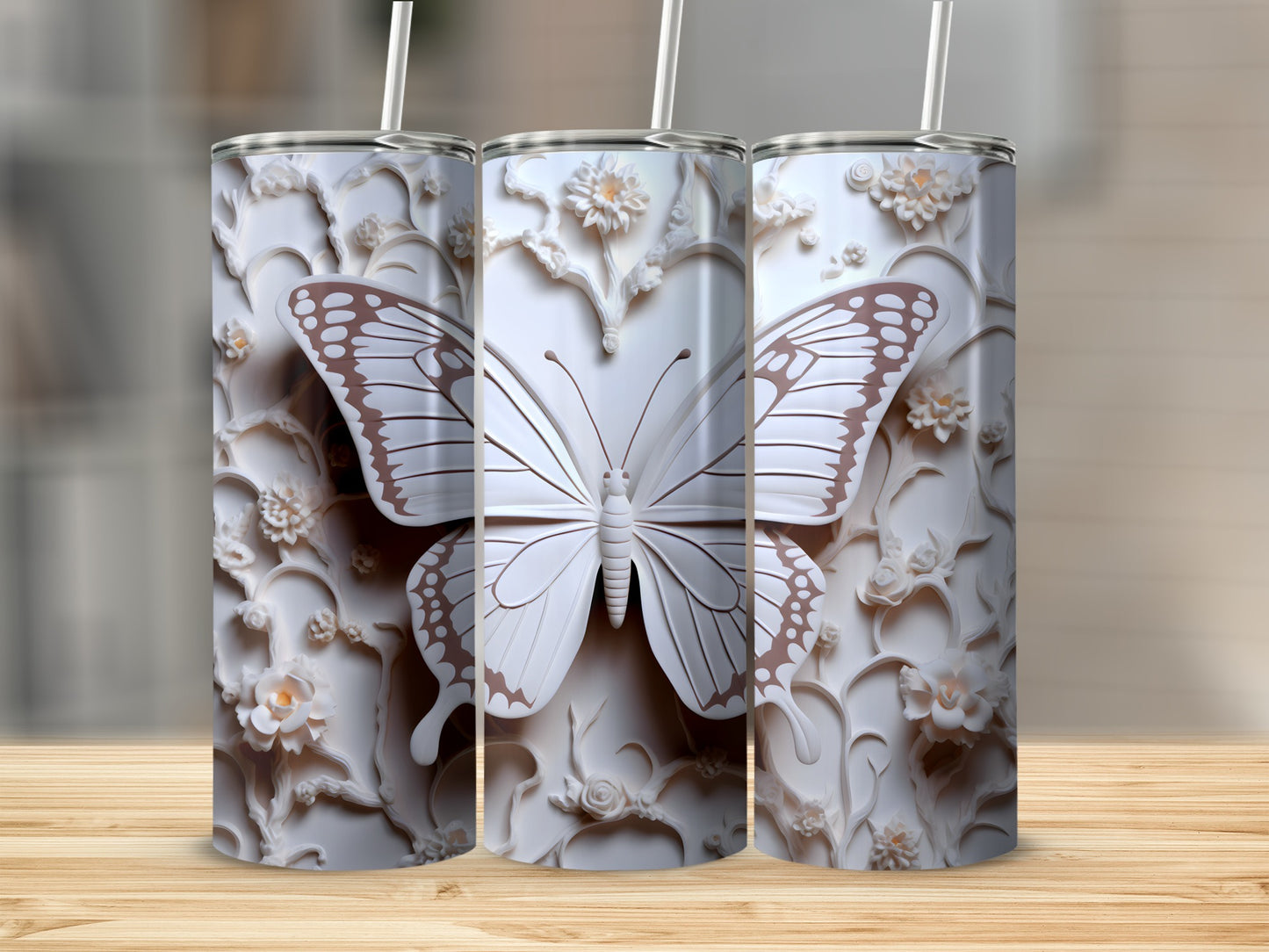Three white tumblers with embossed butterfly and floral designs.