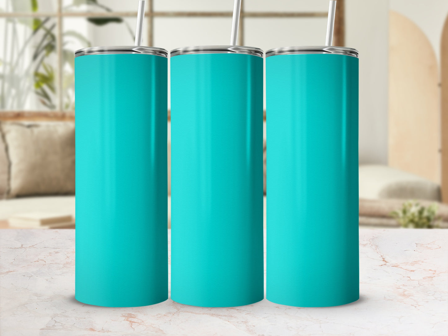 Three teal tumblers with straws on a marbled surface.