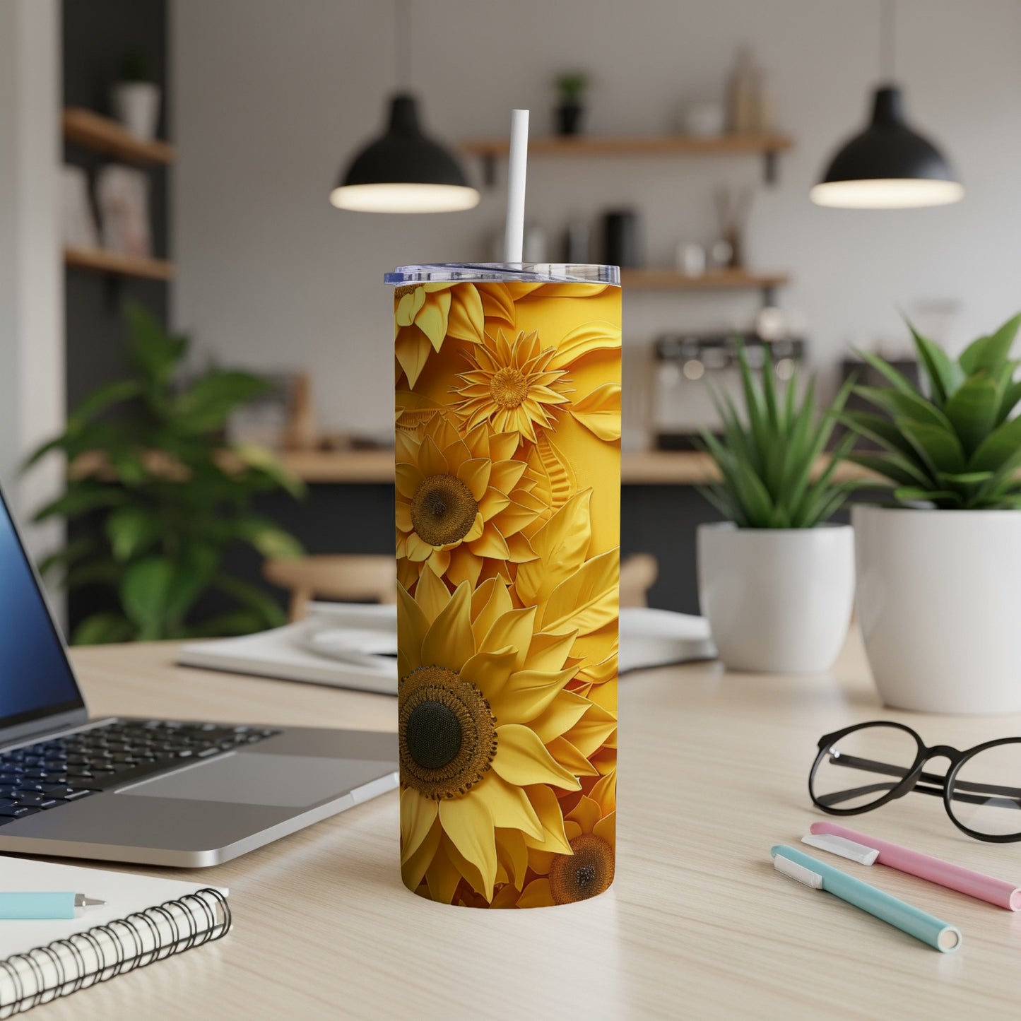 Yellow floral tumbler with sunflower design on a desk.
