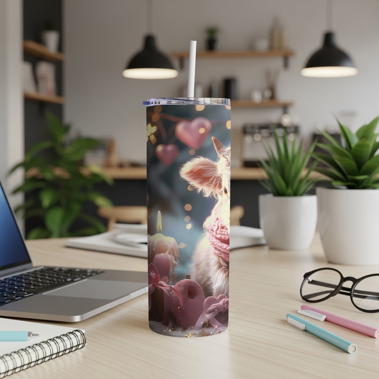 Pink cow with scarf on tumbler with candles and hearts in background.