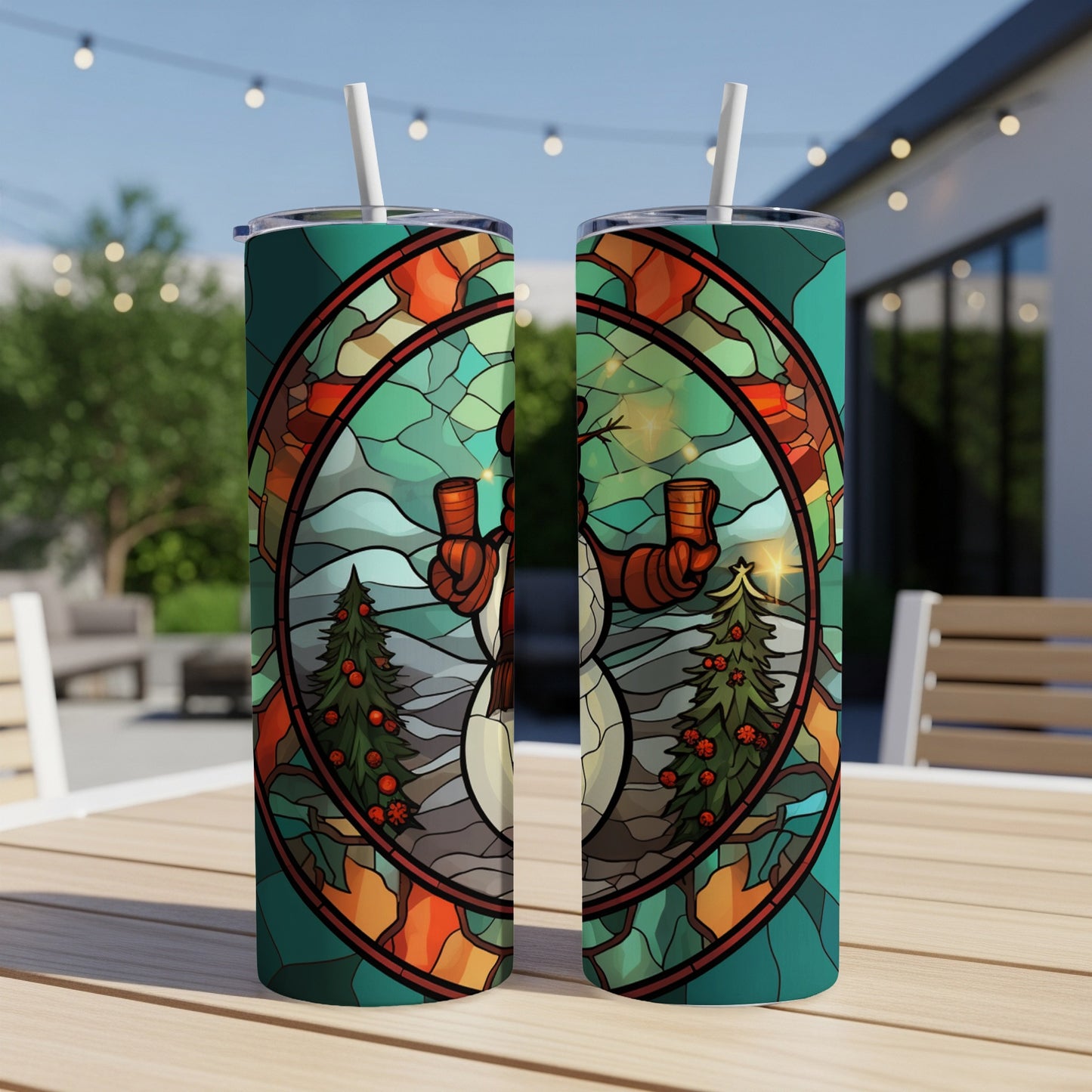Two skinny tumblers with a stained-glass snowman and Christmas tree design.