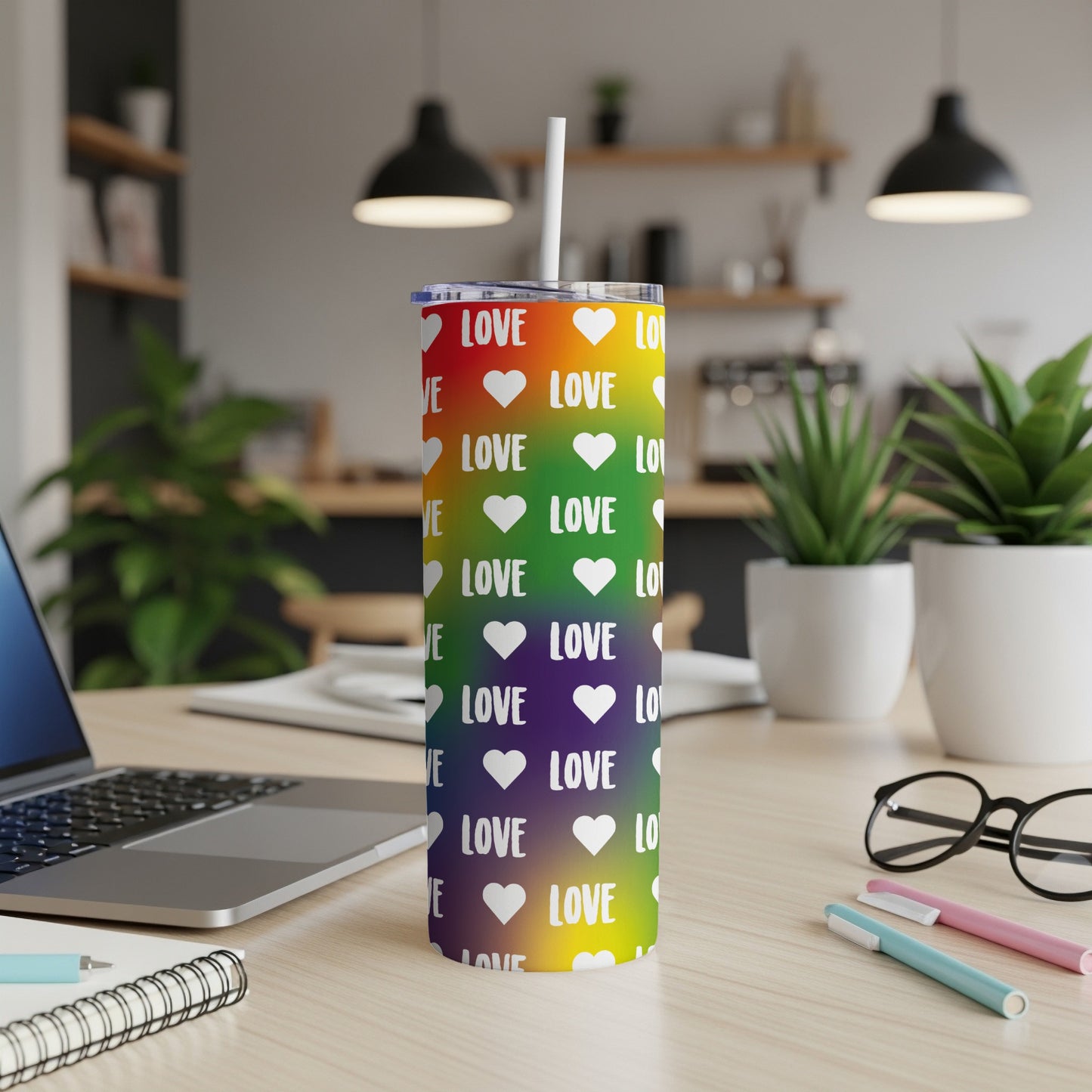 Rainbow tumbler with "LOVE" repeated in white hearts and text.