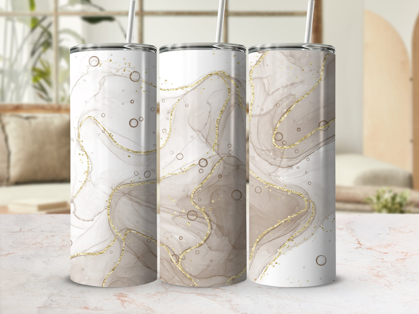 Three tumblers with a marbled abstract design in beige and gold.