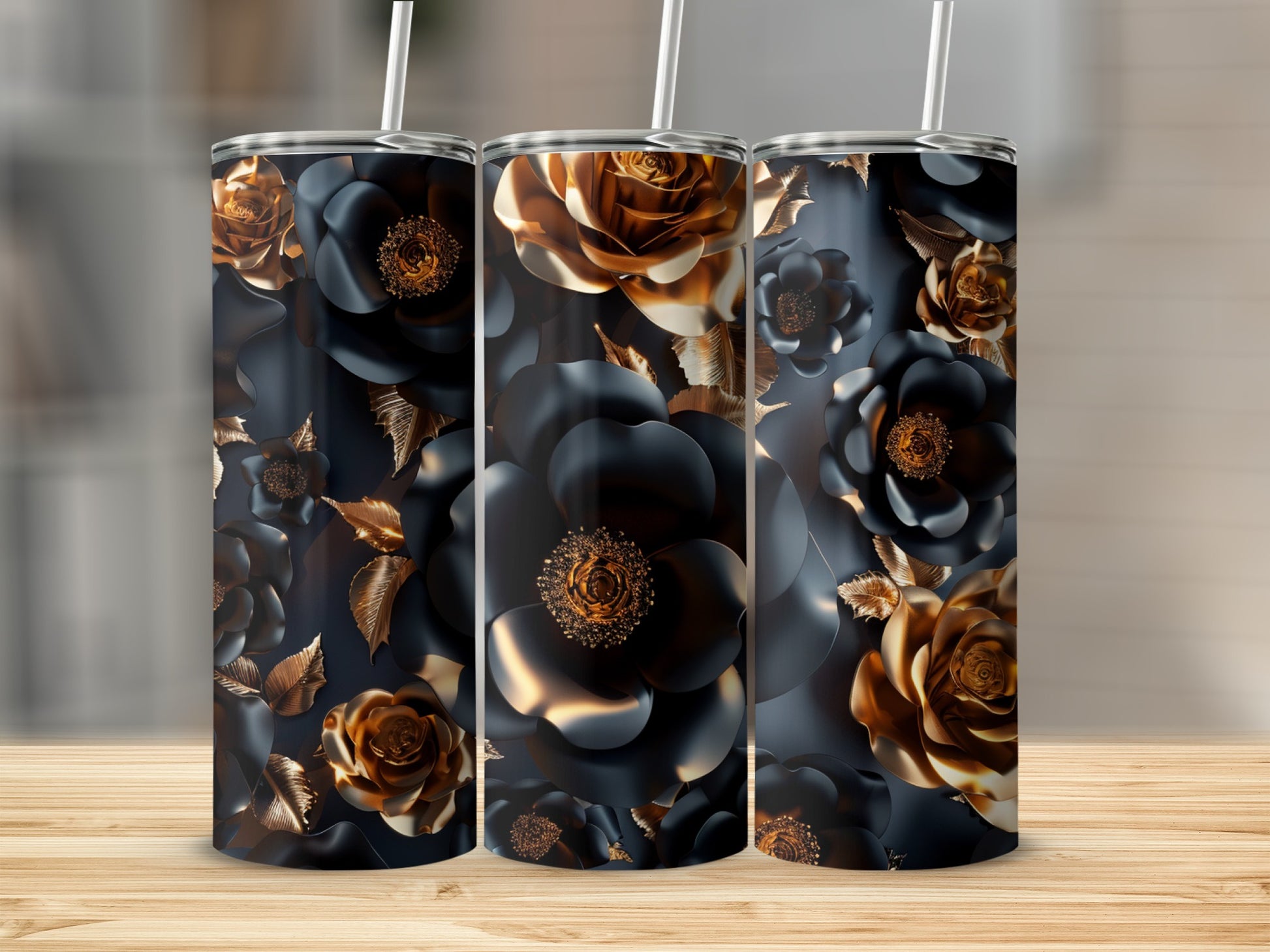 Three dark floral pattern tumblers with gold accents on a wooden surface.