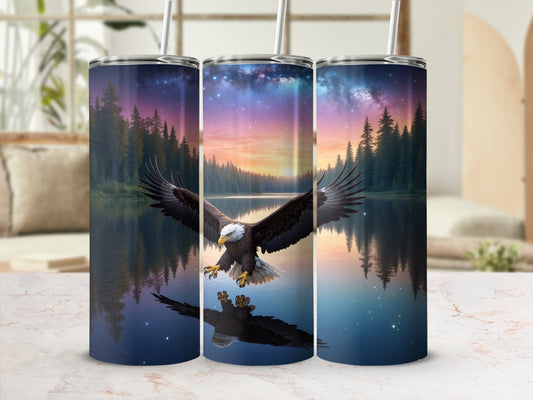 Tumbler with a bald eagle soaring over a lake at sunset.