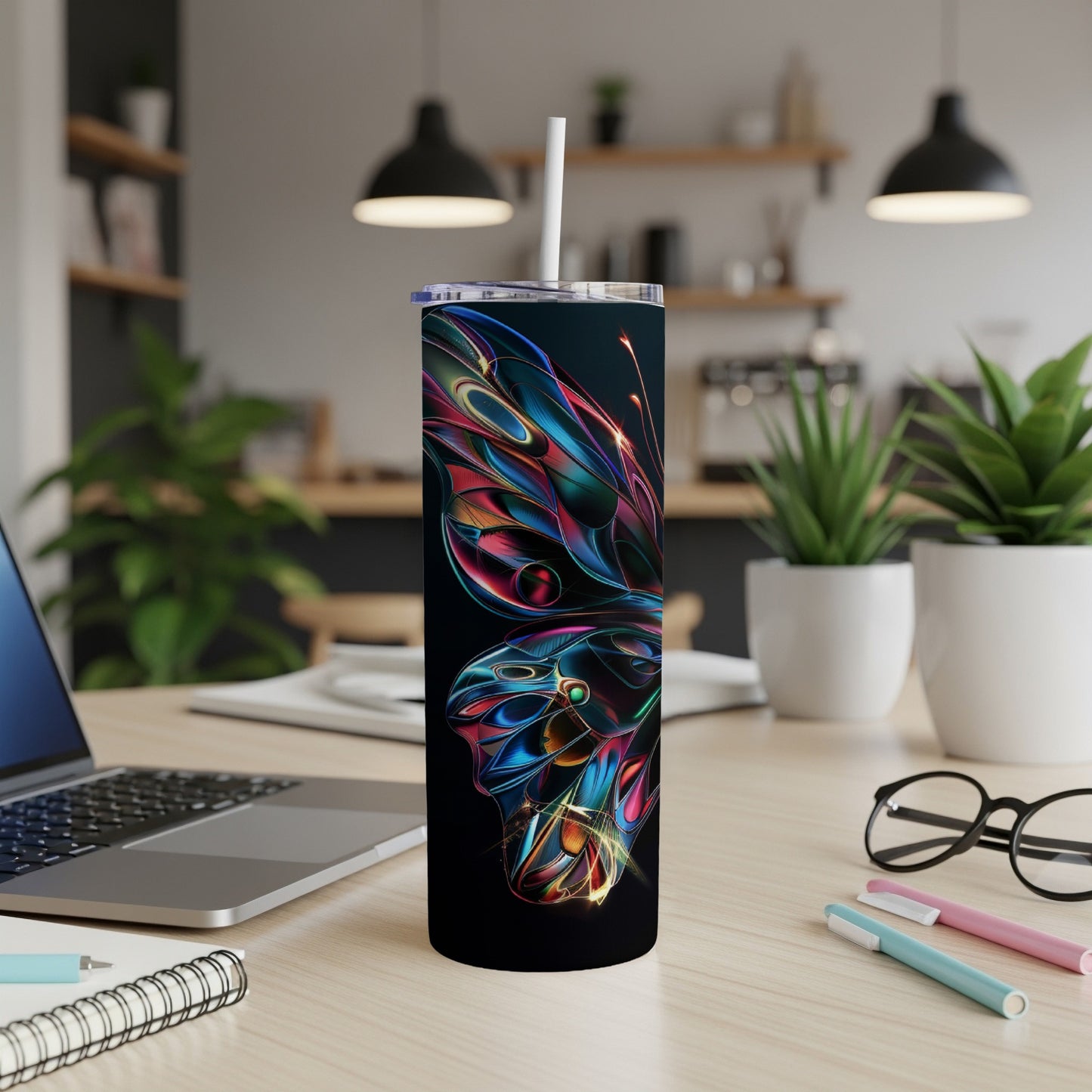 Black tumbler with colorful abstract butterfly design and straw.