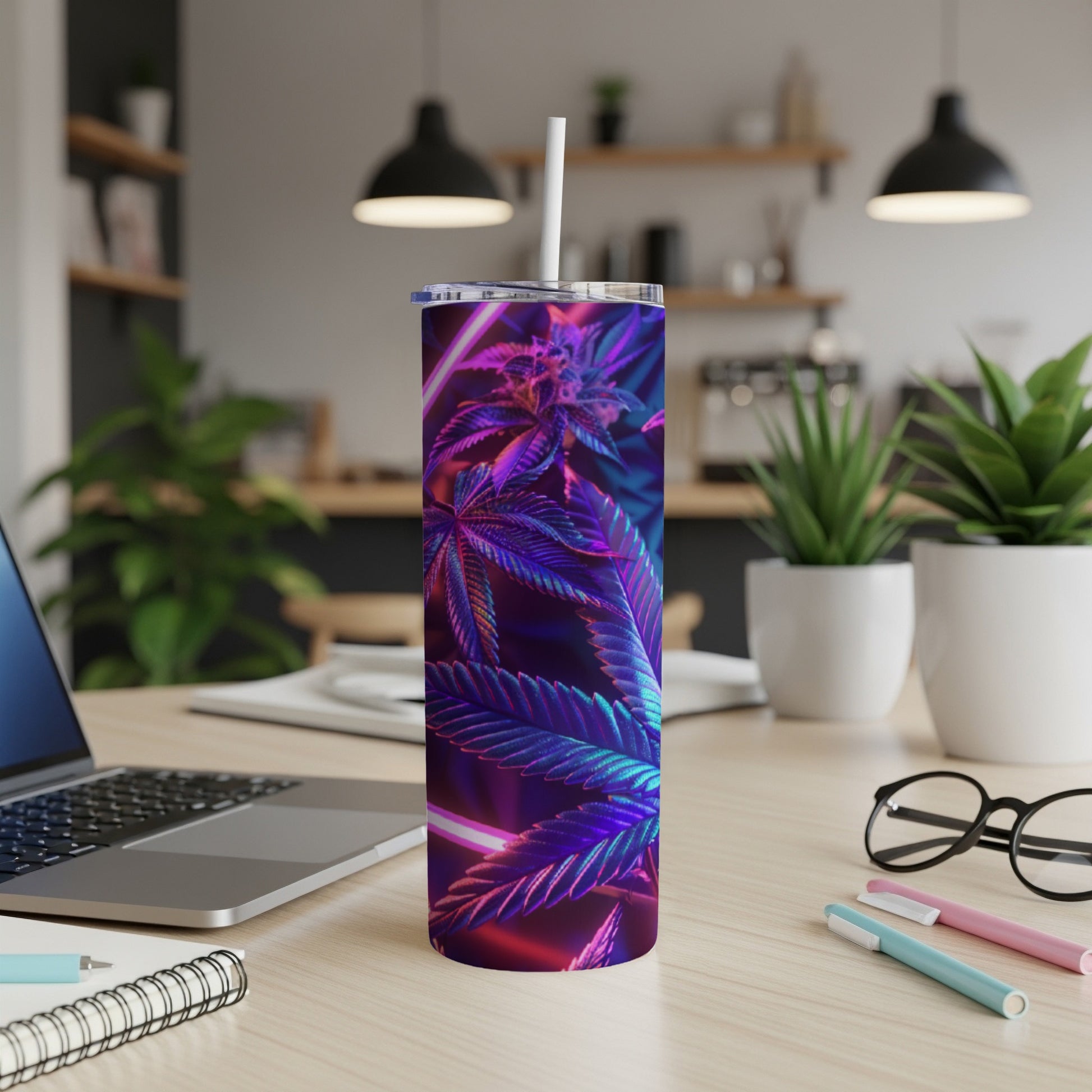 Cannabis leaf design on a blue and purple iridescent tumbler with a straw.