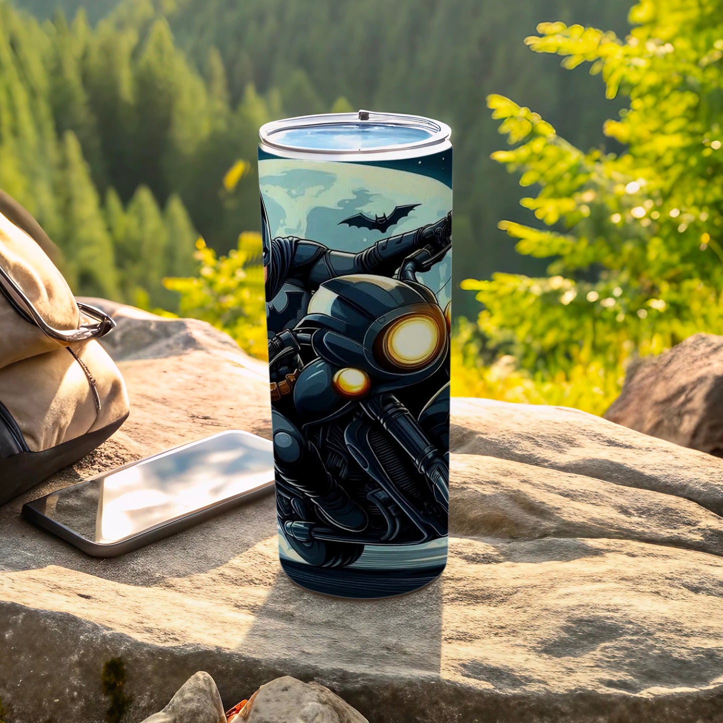 Batman motorcycle on a tumbler, with a wooded mountain background.