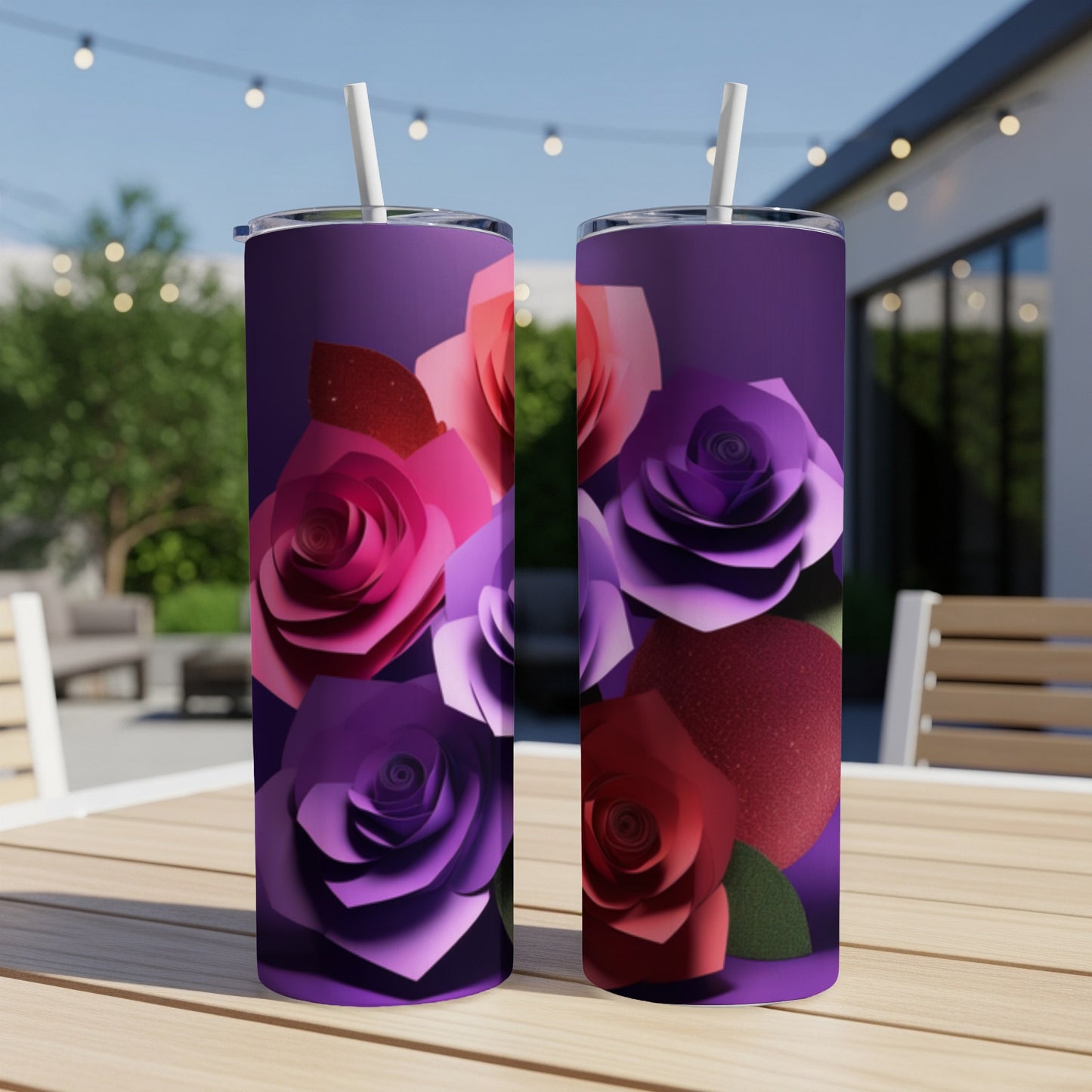 Two purple tumblers with cutout rose designs sit on a table outdoors.