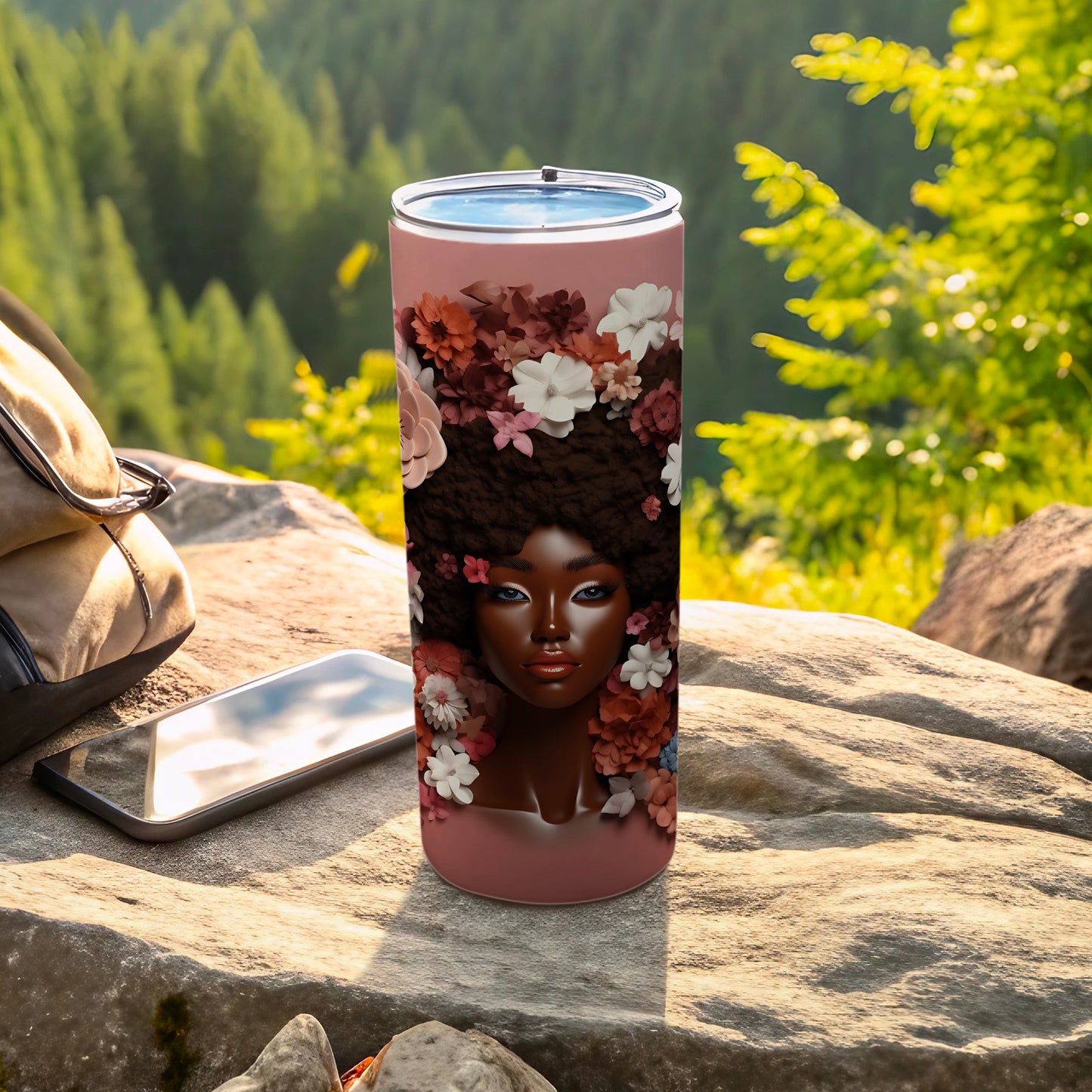 Tumbler with a portrait of a woman with flowers in her hair.