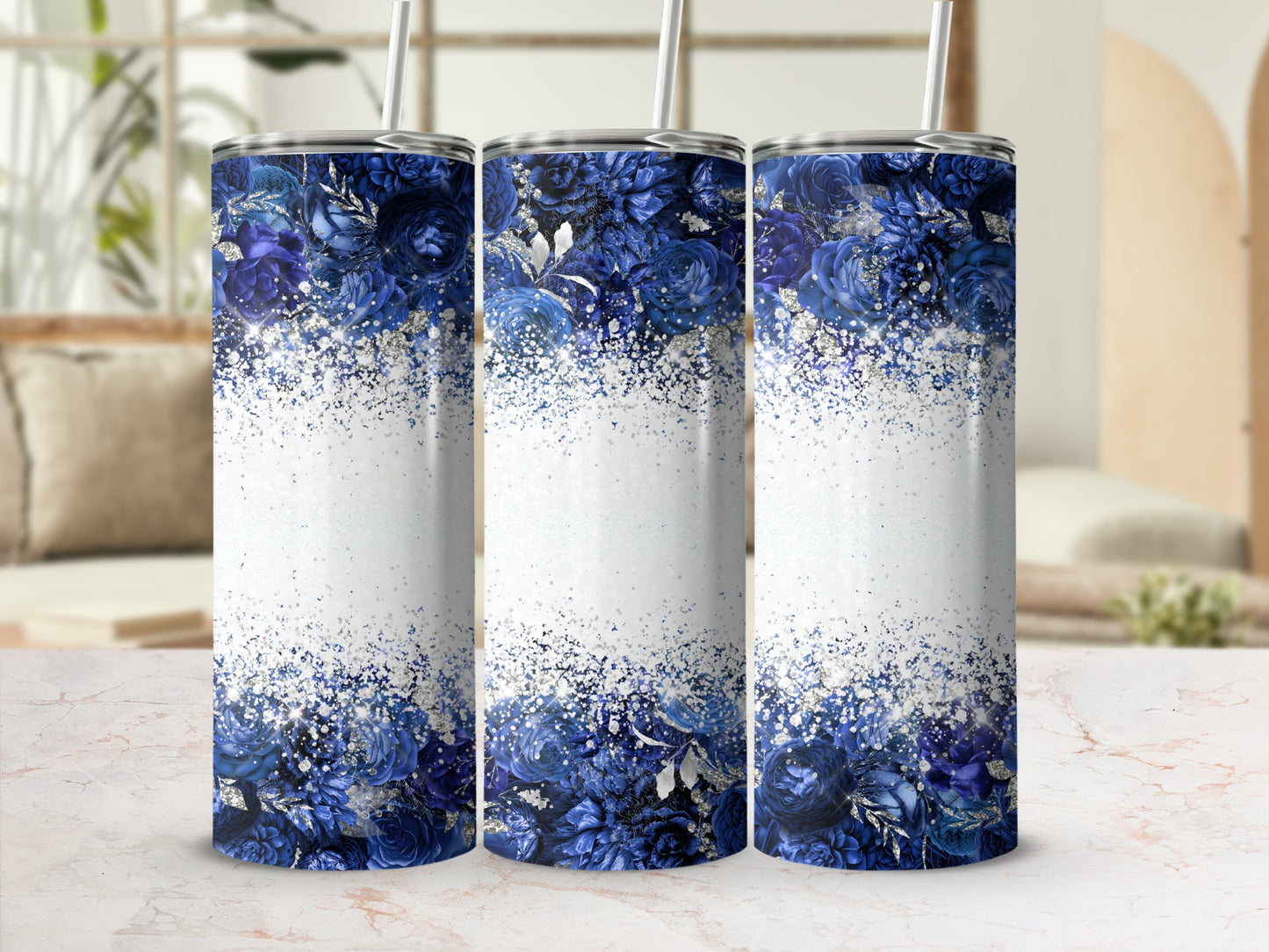 Three tumblers with blue floral and glitter designs.