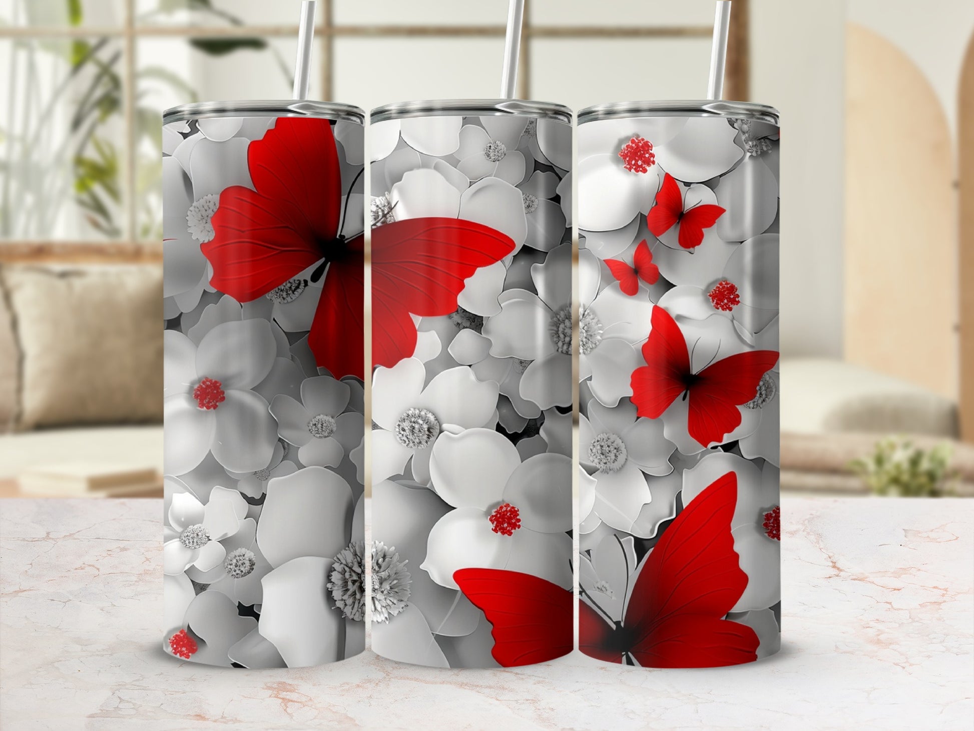 Three tall tumblers with a white floral and red butterfly design.