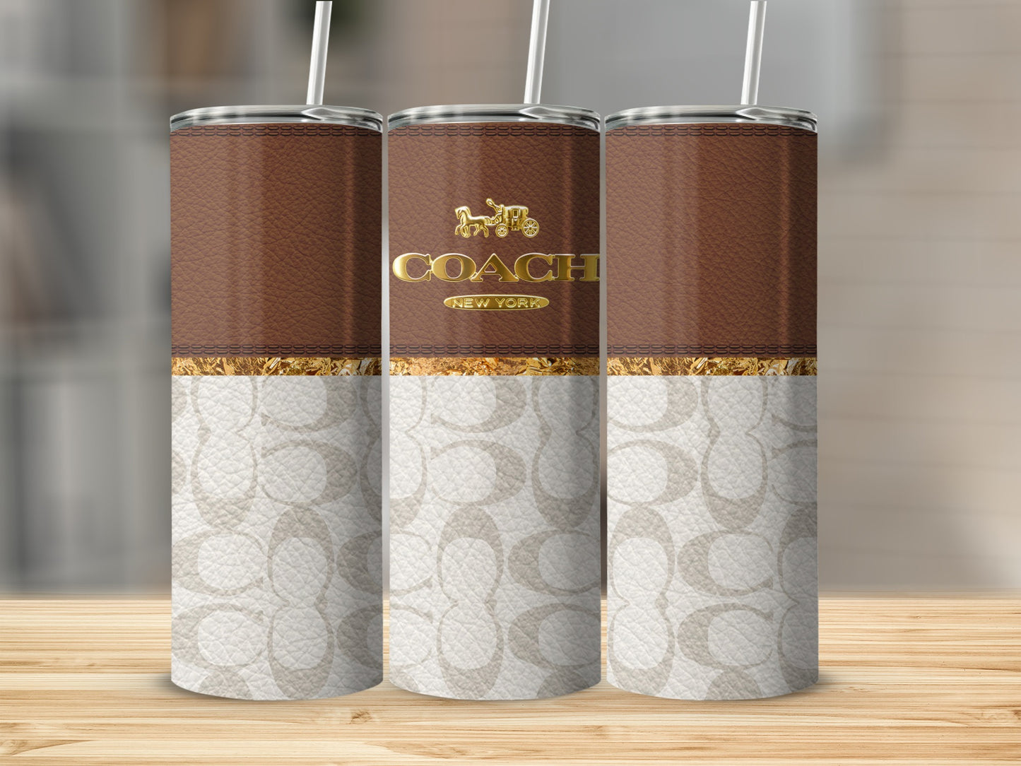 Three Coach New York tumblers with brown leather and monogram patterns.