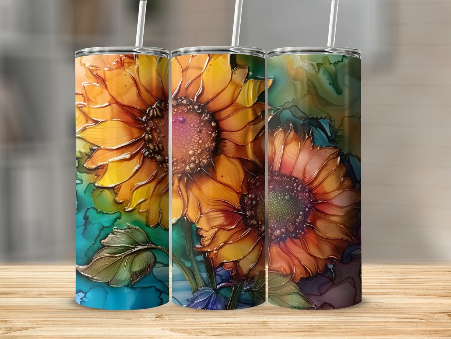 Three tumblers featuring vibrant watercolor sunflowers on a wooden surface.