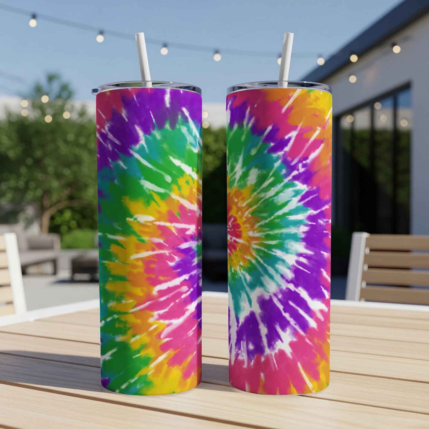 Two tumblers with colorful tie-dye pattern on a table.