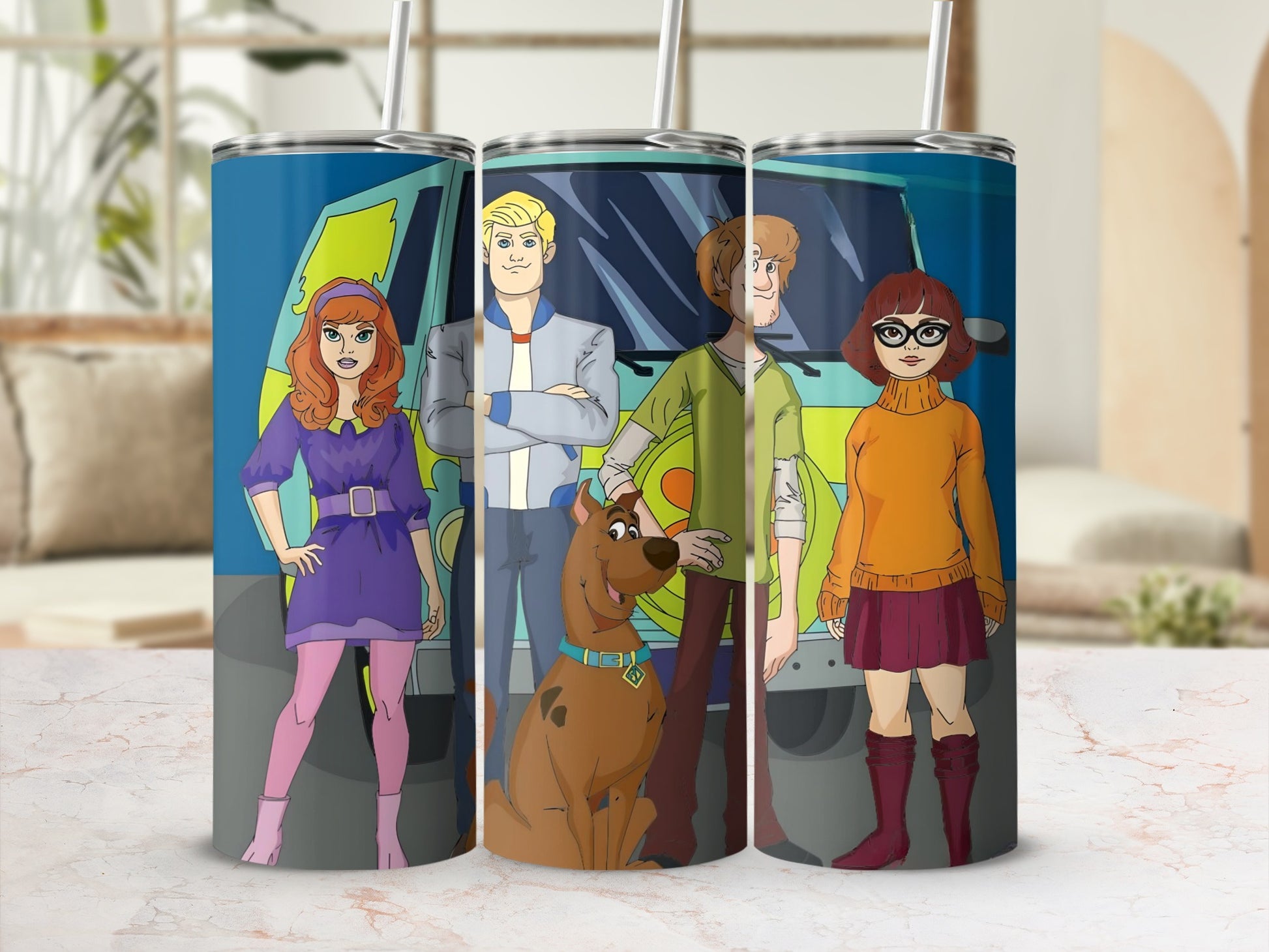 Scooby-Doo characters Daphne, Fred, Shaggy, Velma, and Scooby-Doo on a teal tumbler.