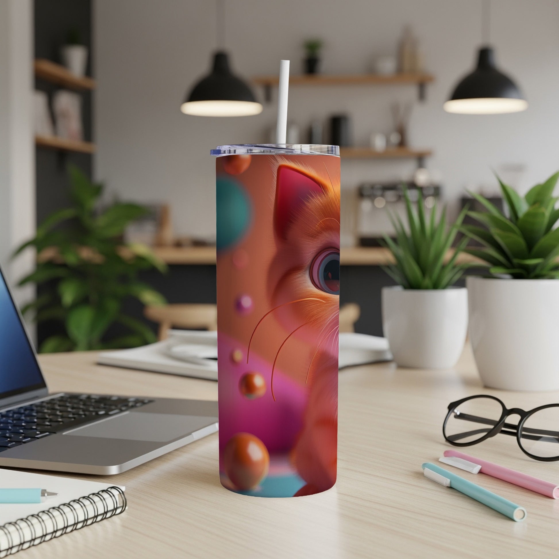 Orange tabby cat face on a pink and orange bubble tumbler with a straw.