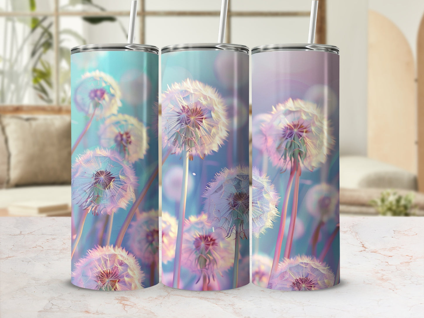 Three tall tumblers with dandelion designs on a marble surface.