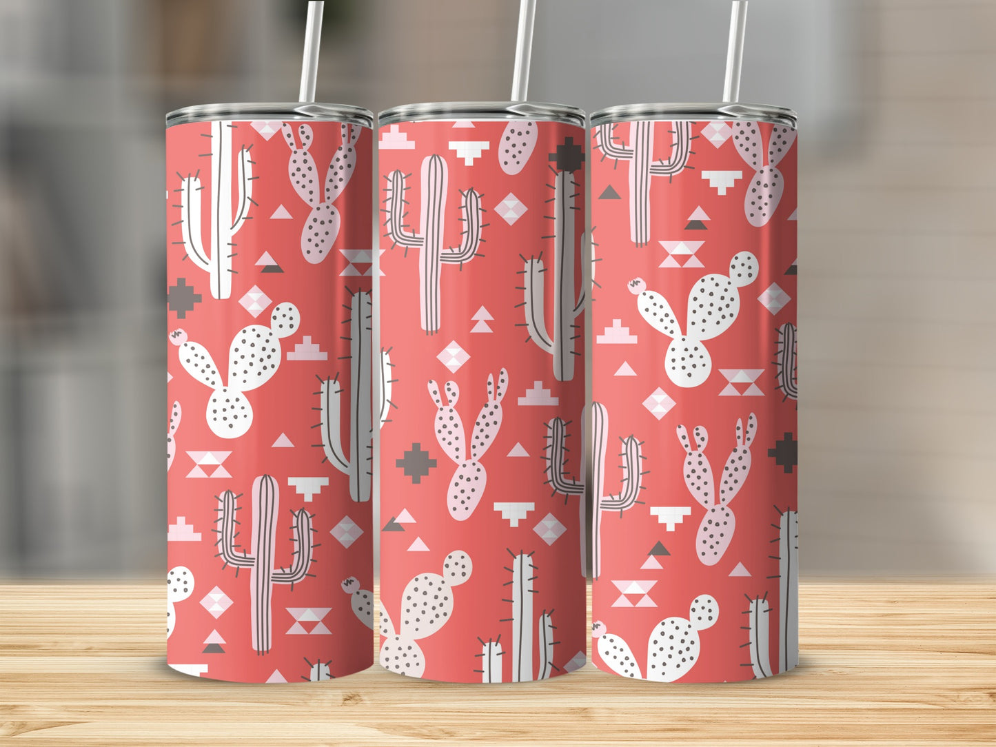 Three tall tumblers with a coral background and white cactus and geometric patterns.