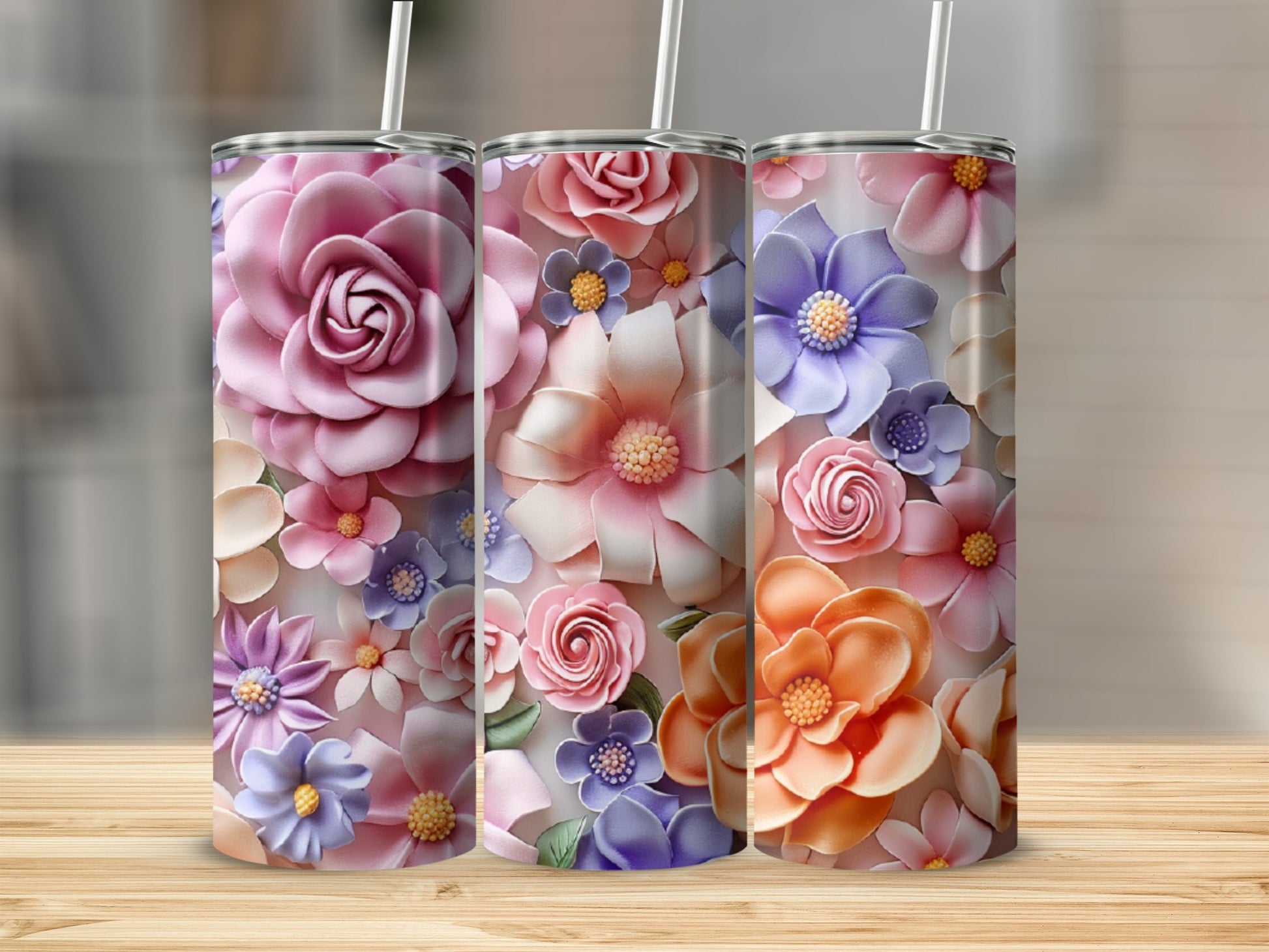 Three floral pattern tumblers with pink, purple, and orange blossoms.