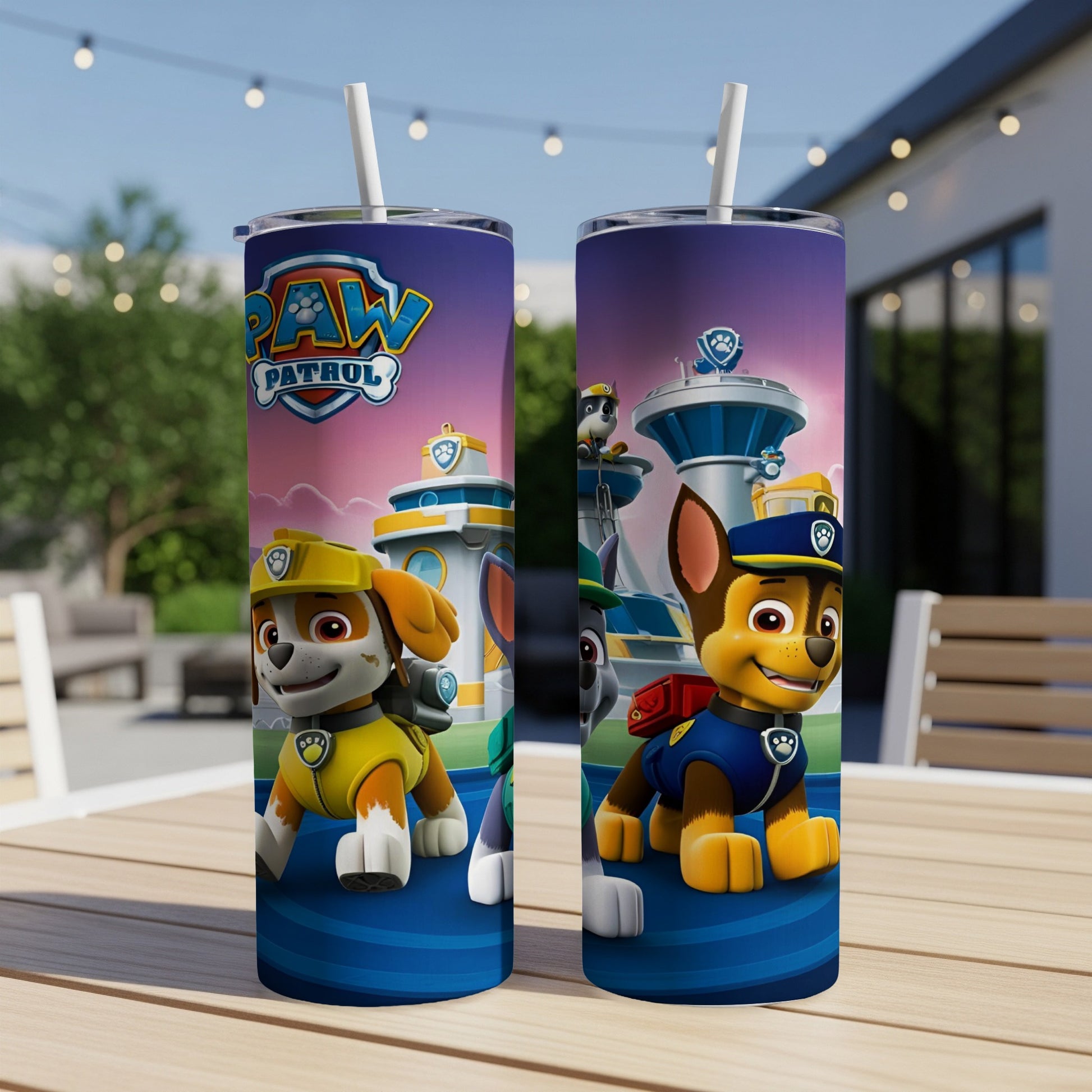 Two Paw Patrol tumblers featuring Chase and Ryder on a patio table.