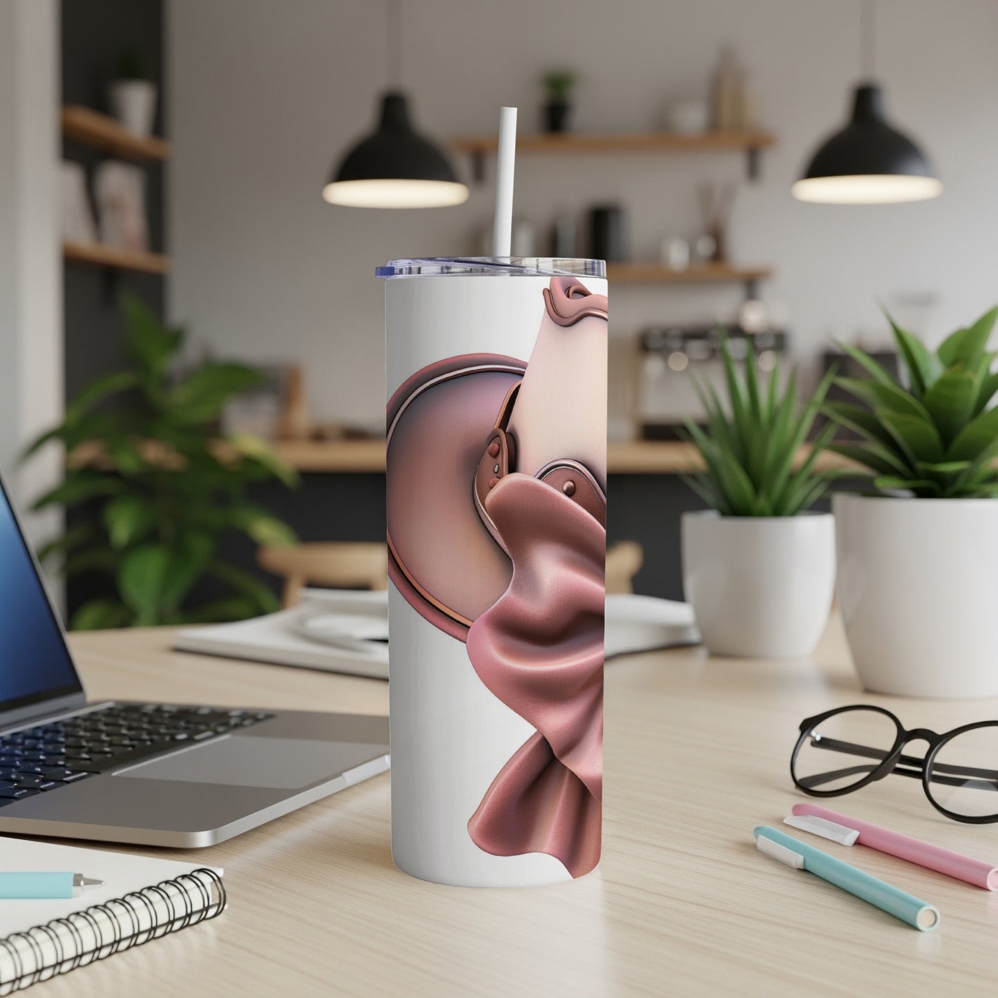 White tumbler with rose gold draped fabric design on desk.