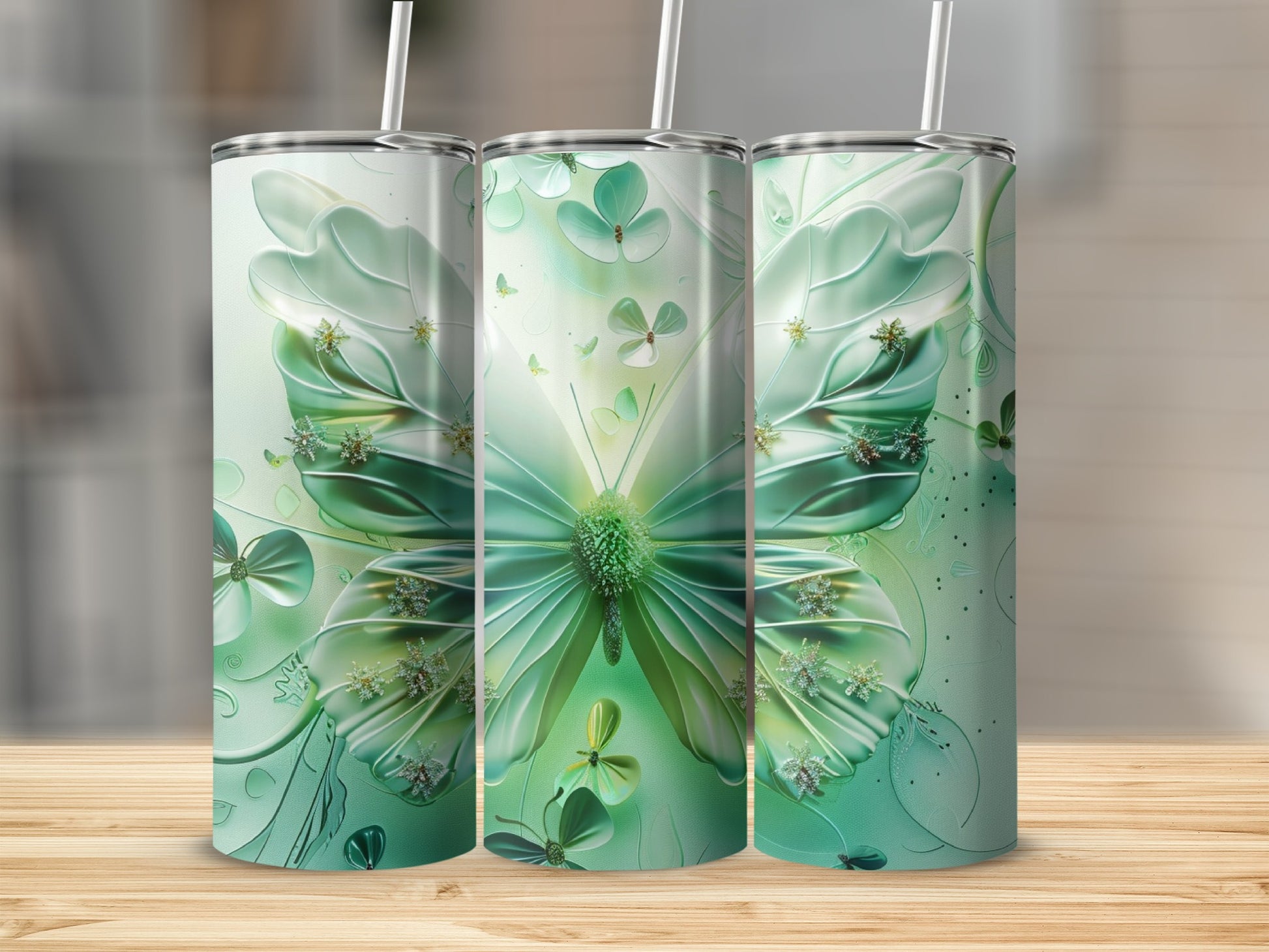 Green butterfly and clover pattern on three tall, skinny tumblers.