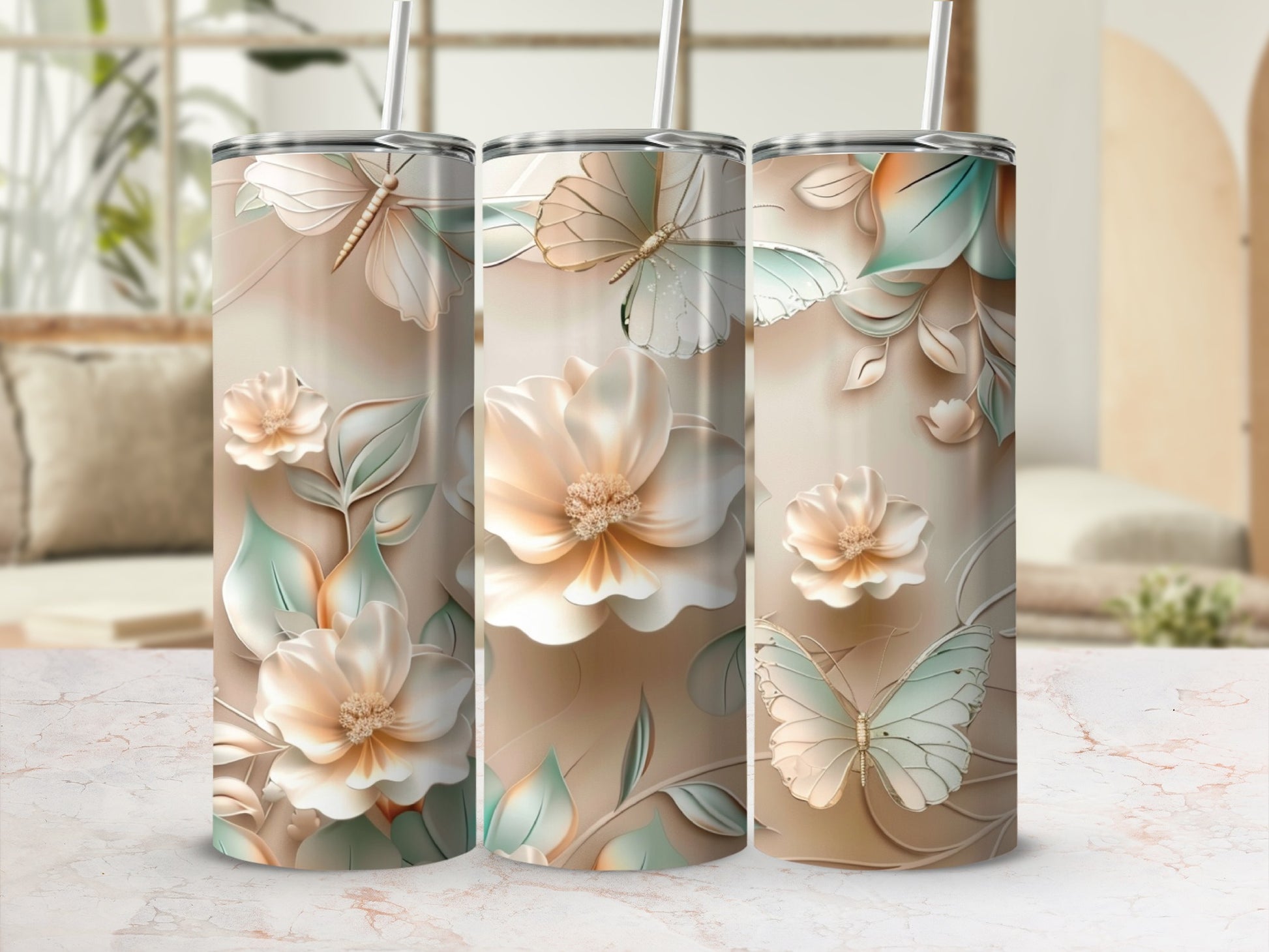 Triptych of tall tumblers with floral and butterfly designs.